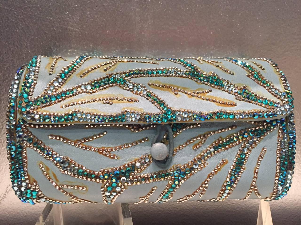 A beautiful 1950s Koret aqua blue leather barrel clutch, embellished with white and azure rhinestones in a branch-like pattern.