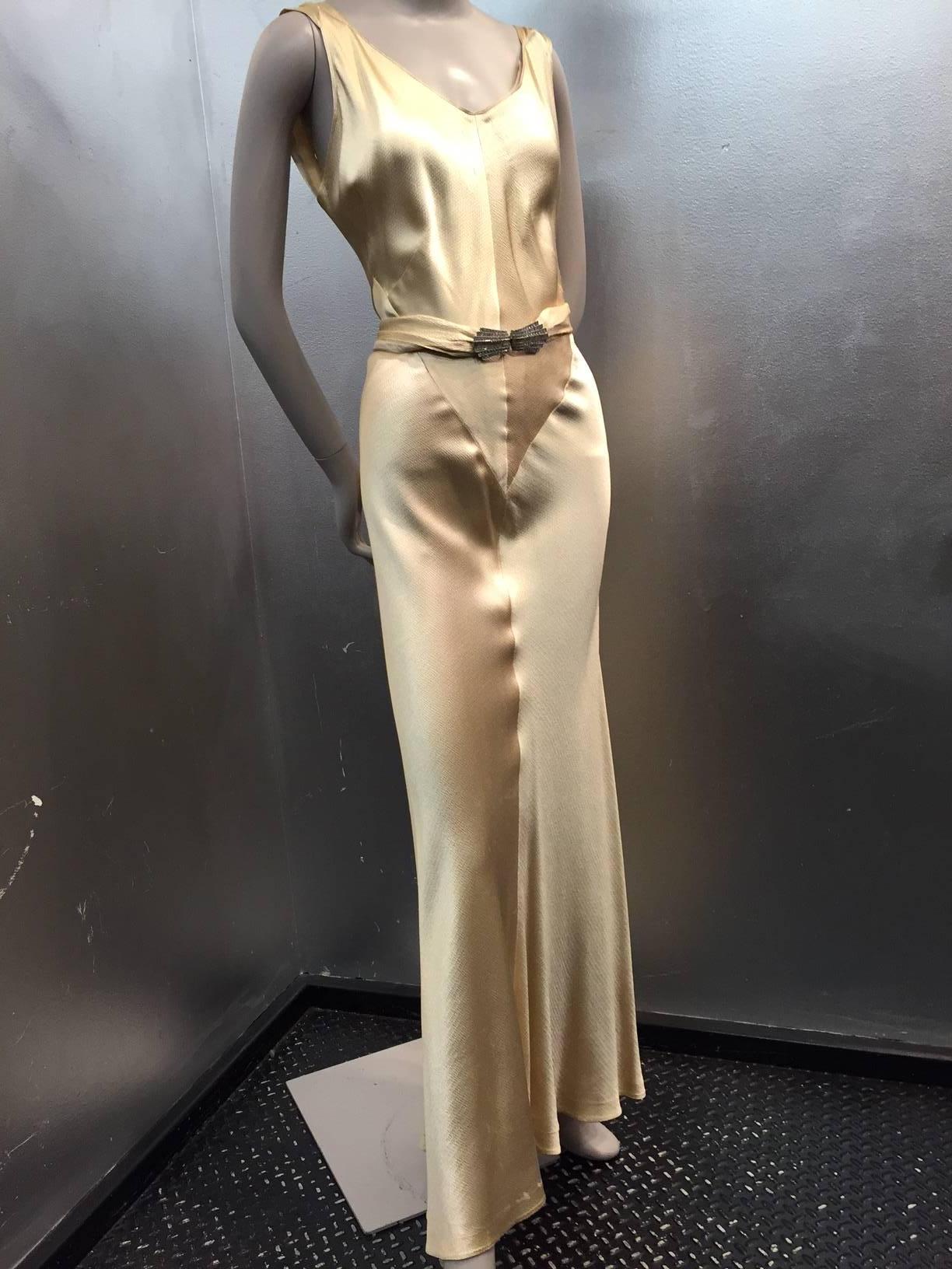 A divine 1930s champagne gold hammered silk satin bias-cut Art Deco evening gown with wrap-back and rhinestone belt buckle detail.  Low, low plunging back and genius seaming throughout.  Spectacular. 
