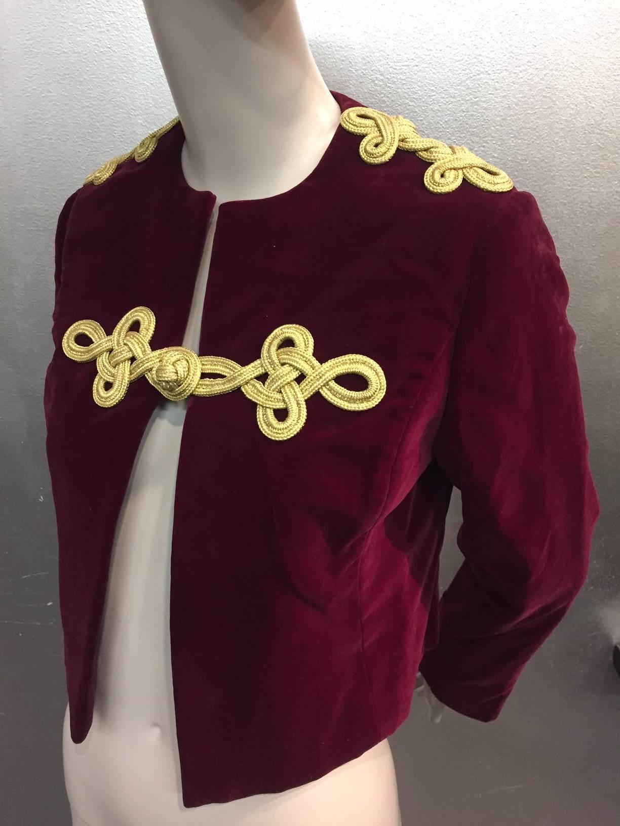 1960s Bill Blass burgundy velvet jacket with gold braid epaulets and frog closure.  Fully lined. Slit at cuff.