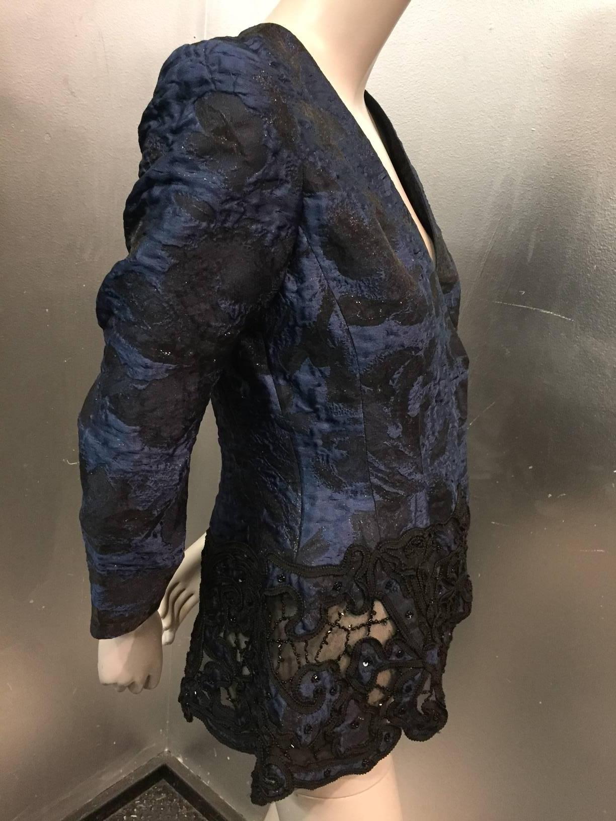 Oscar de la Renta navy and black brocade dinner jacket with peplum of cut-out re-embroidered lace. Hidden wrap closure. 