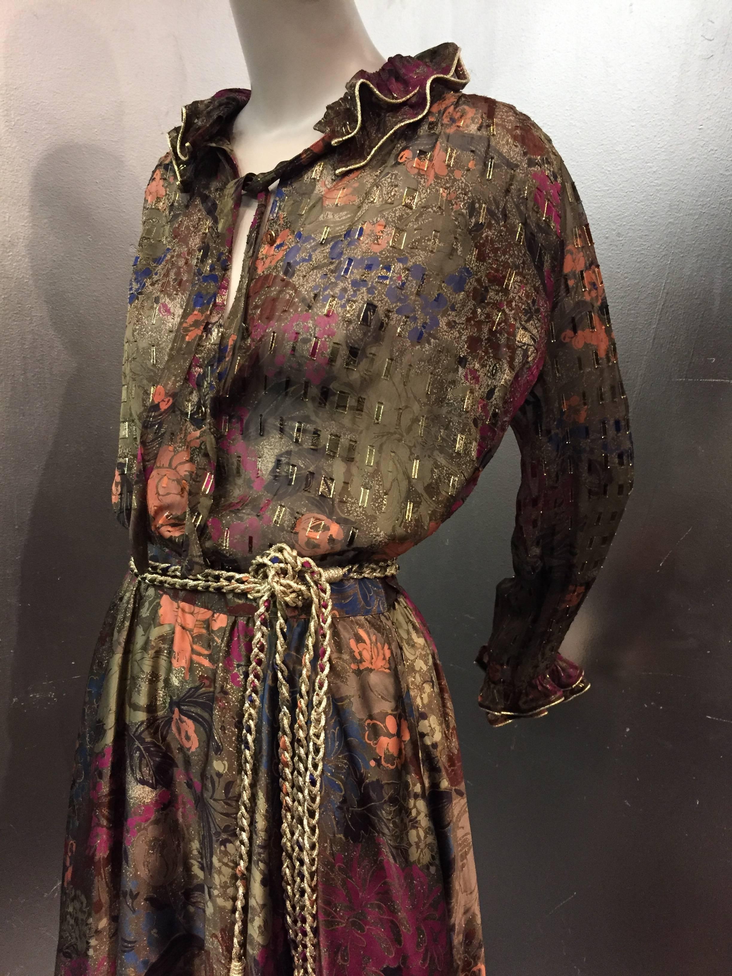 1980s Louis Feraud autumnal-hued floral print silk chiffon 2-piece ensemble:  Ruffled neckline and cuffs trimmed with lamé piping on unlined blouse. Skirt is lined, full and trimmed with chiffon ruffle.  Gold lamé braid belt included. 