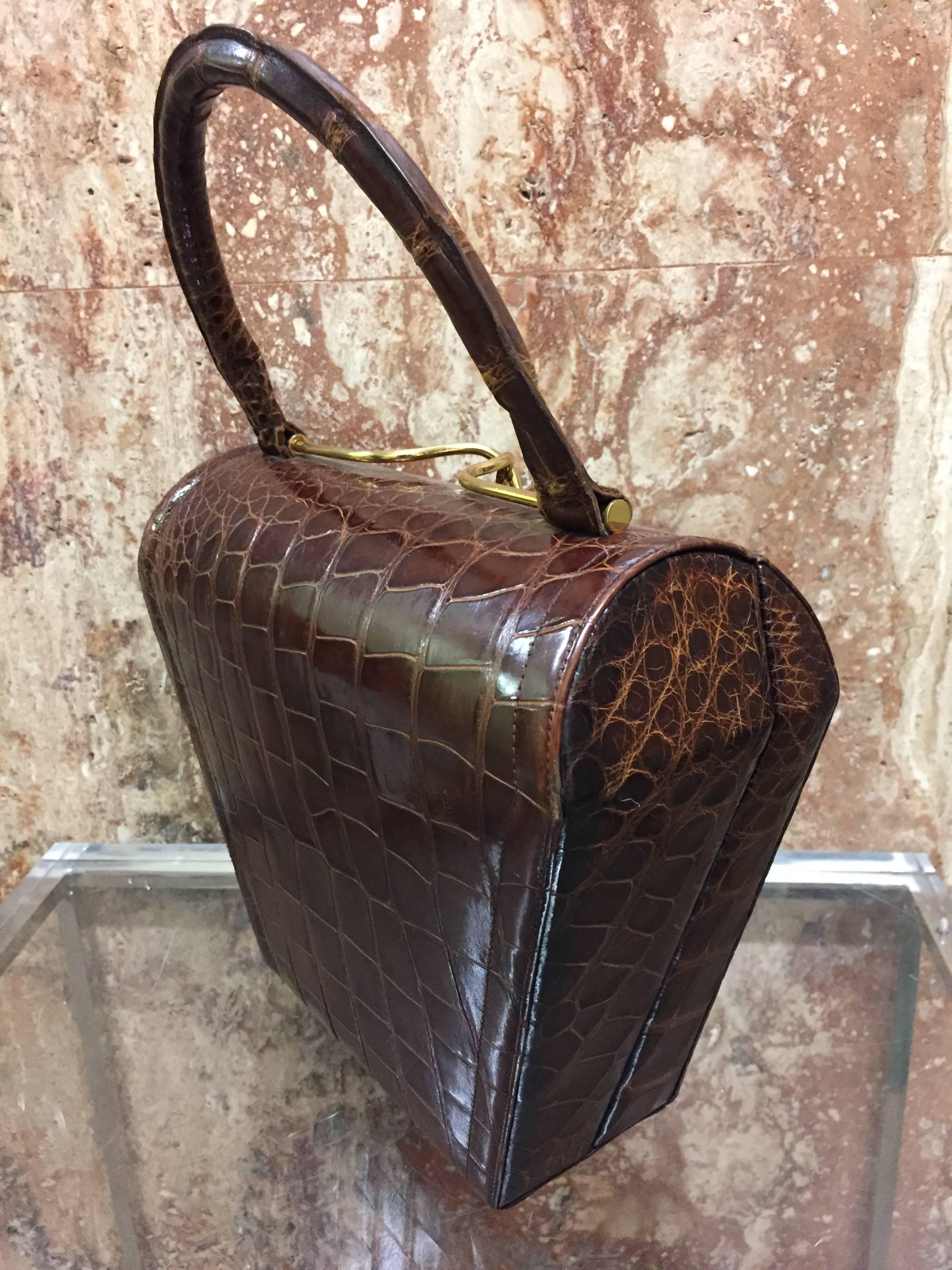 A classic tailored 1950s Koret brown alligator structured handbag with gold-tone clasp and smooth leather lining. 