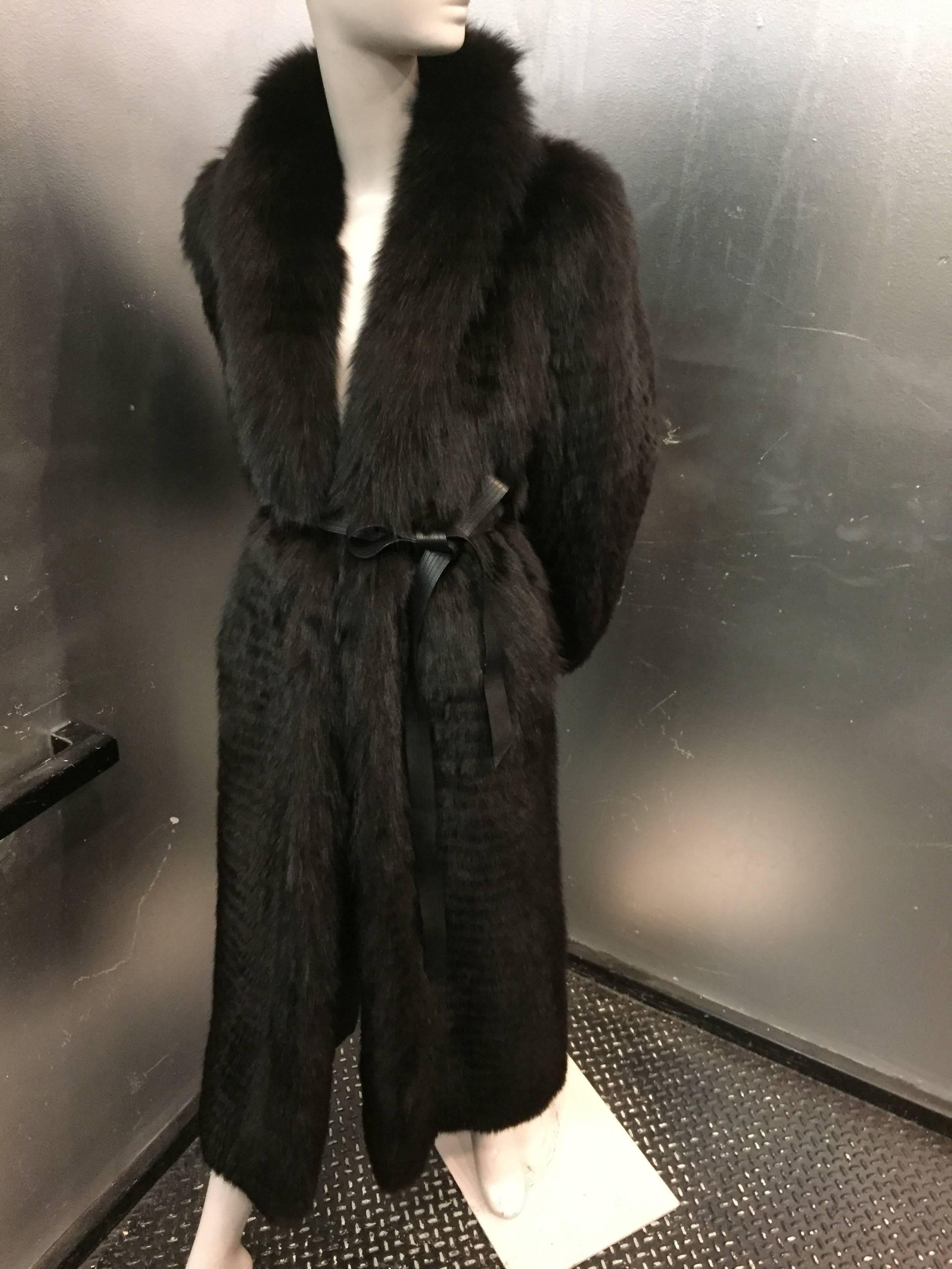 A stunning 1980s Yves Saint Laurent black feathered fox coat with original leather belt. Fully lined.  
