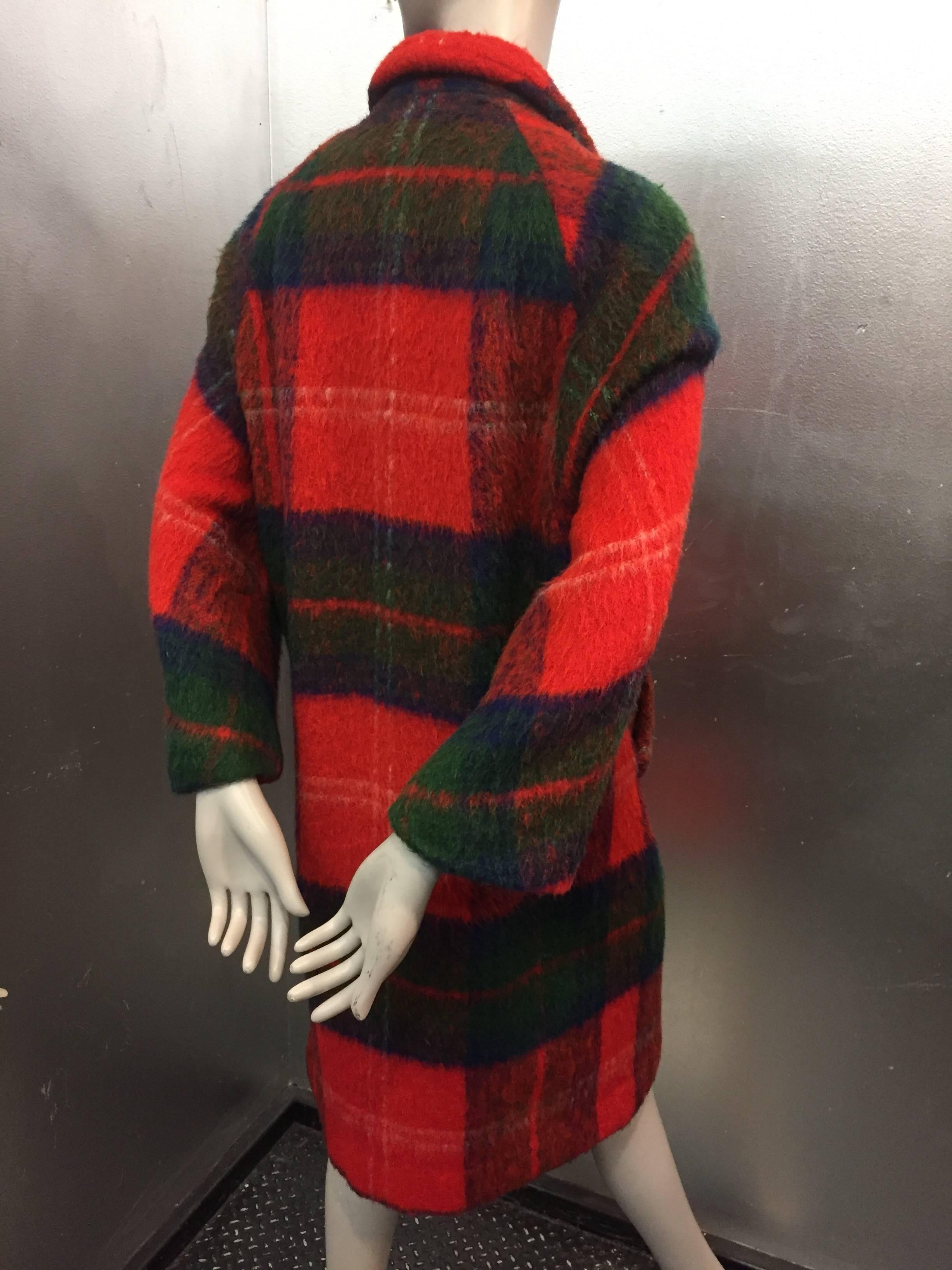 This 1960s Scottish Tartan Plaid Mohair Mod Coat in Lilli Ann Style features 3/4 sleeve and side pouch pockets.  Luxurious saturated plaid print wool mohair with royal purple silk lining.

 