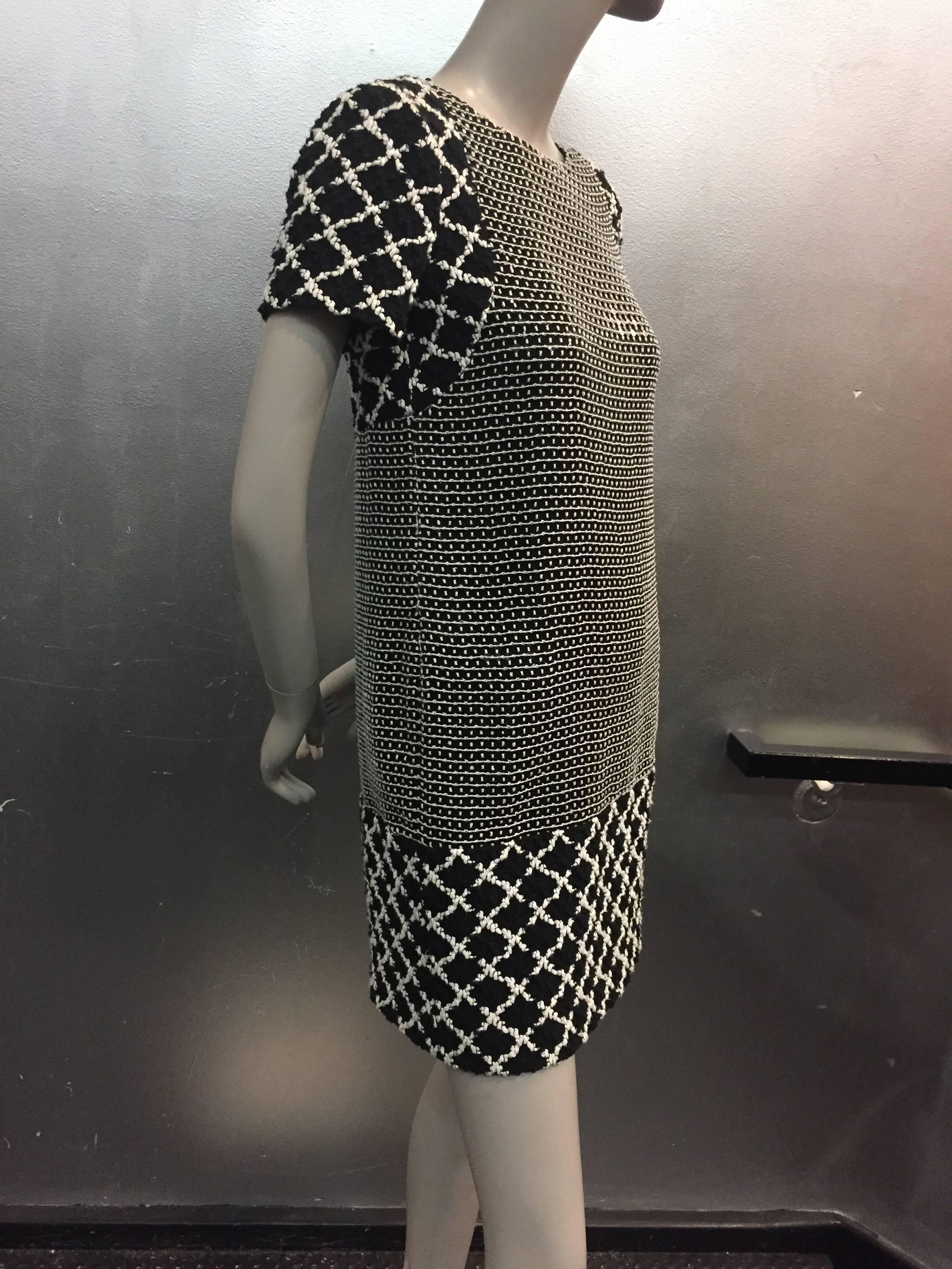 A true classic Chanel black and white cap sleeved mini ...easy to wear and no fuss.

Cotton window pane cap sleeve and hem.

Center panel is sequined on woven net, soft and light weight.

Fully lined and zips up the back.

Tres Chic