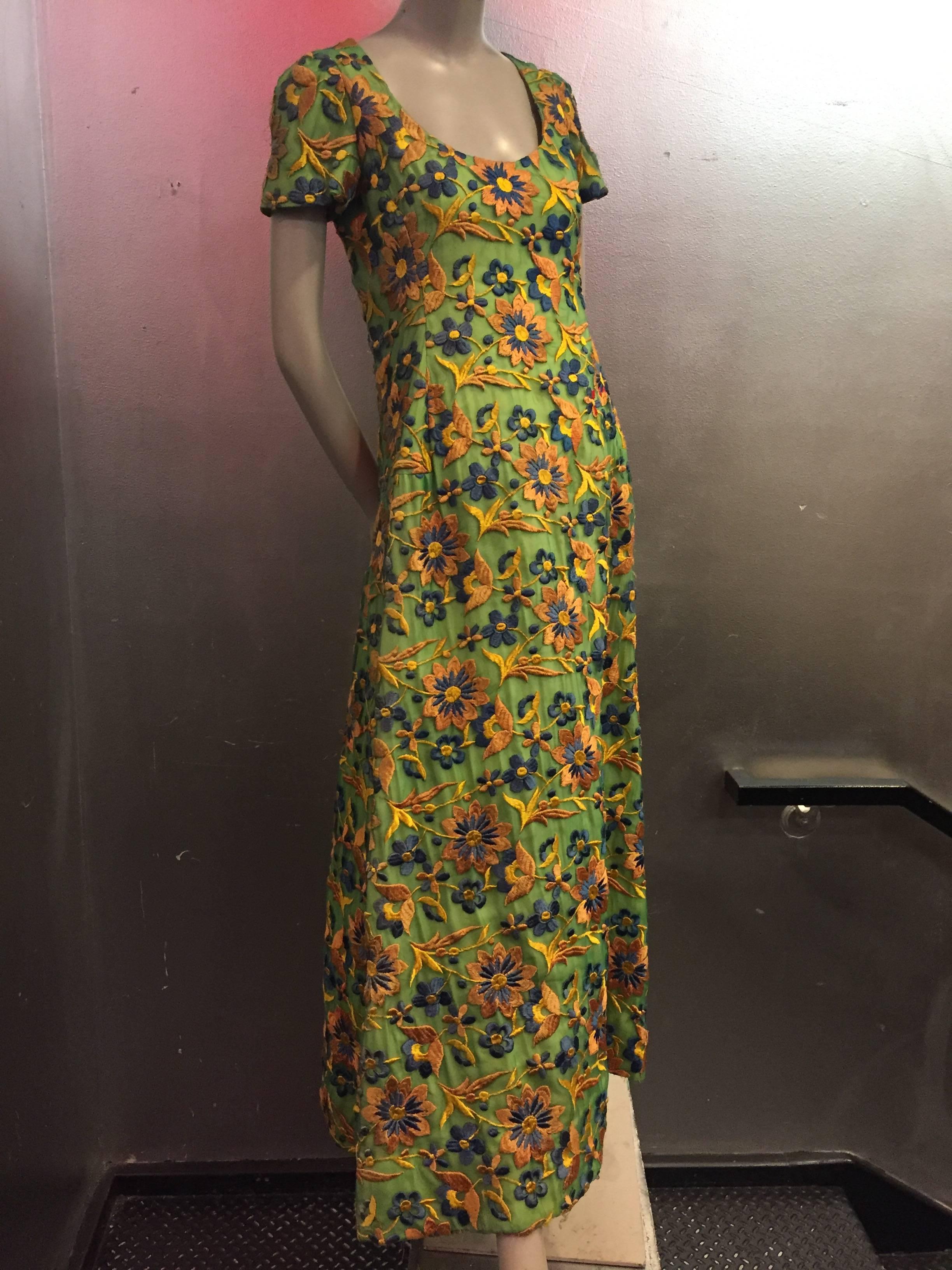 A gorgeous 1960s Arnold Scaasi heavily embroidered silk floral evening gown:  embroidery is similar in technique to an embroidered Spanish shawl, in golds and blues on an apple green silk chiffon background. Cap sleeves, scoop neck and tiered
