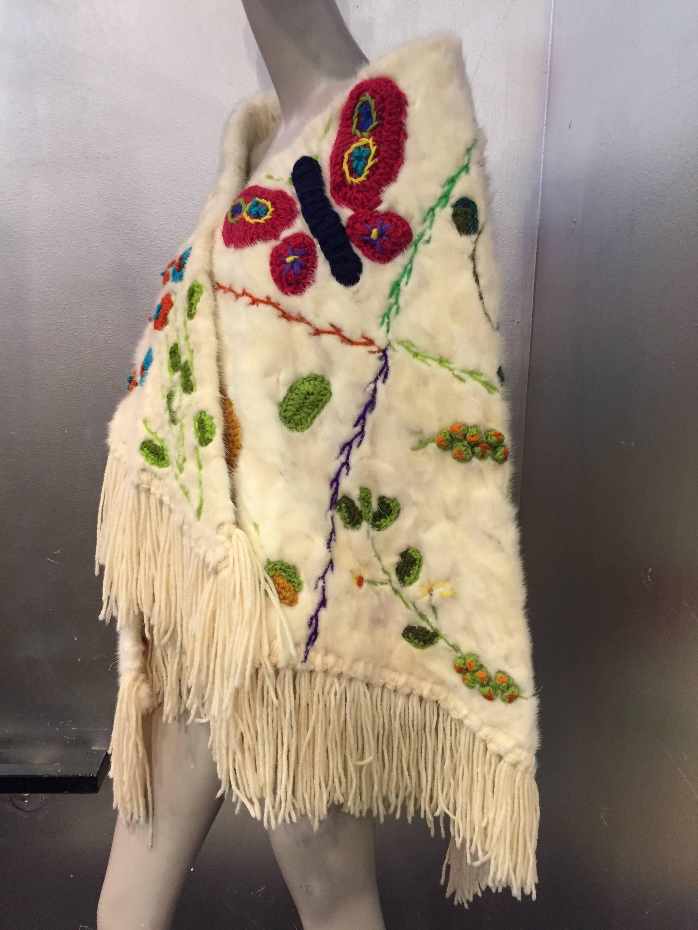 1970s Neiman-Marcus white mink shawl with colorful botanical garden scene embroidered all-over in wool yarn.  Wool yarn fringe. Completely lined in French wool jersey.