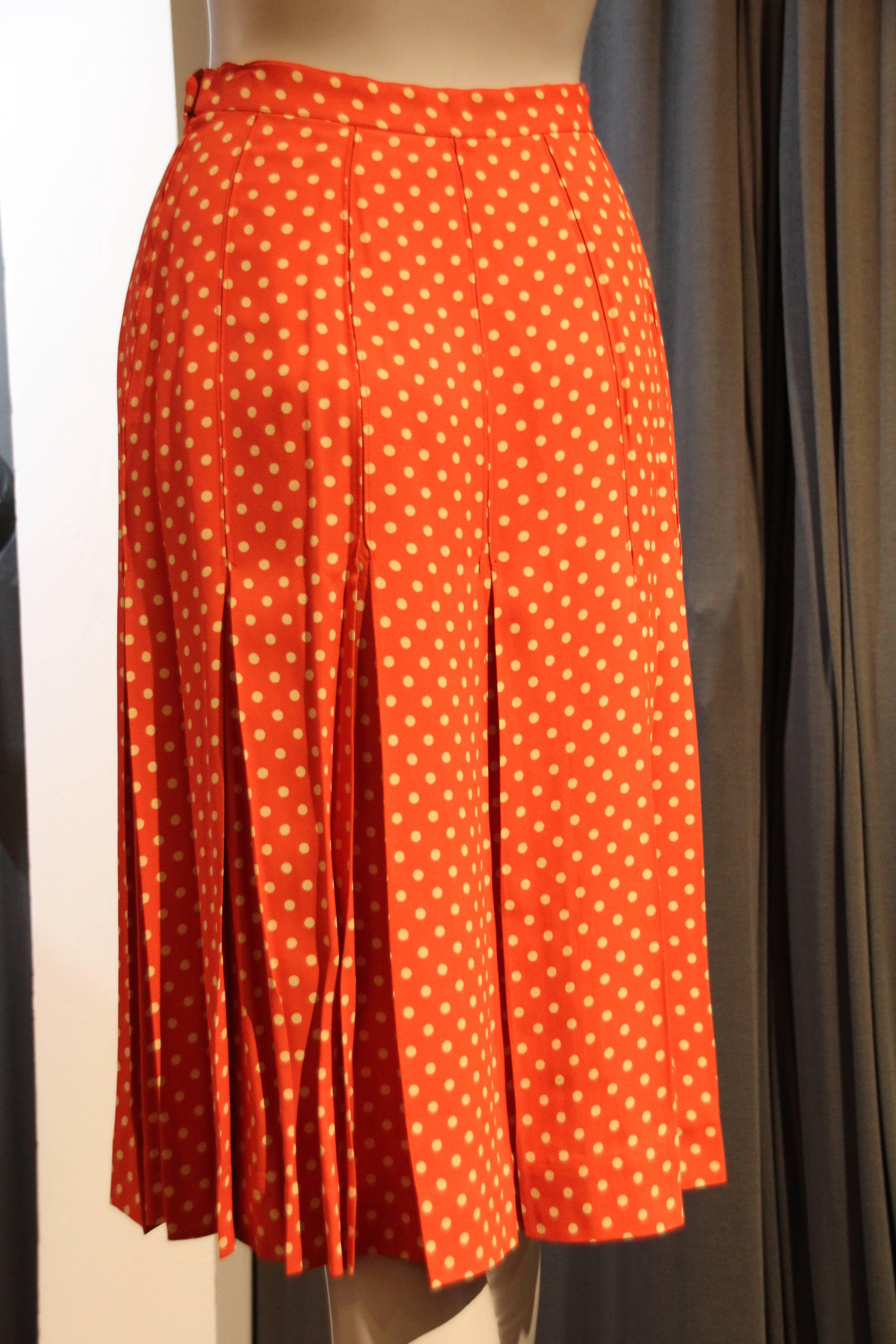 A flirty 1970s Saint Laurent box pleated orange and white polka dot crepe skirt with waistband and zipper.  Just below knee length. 