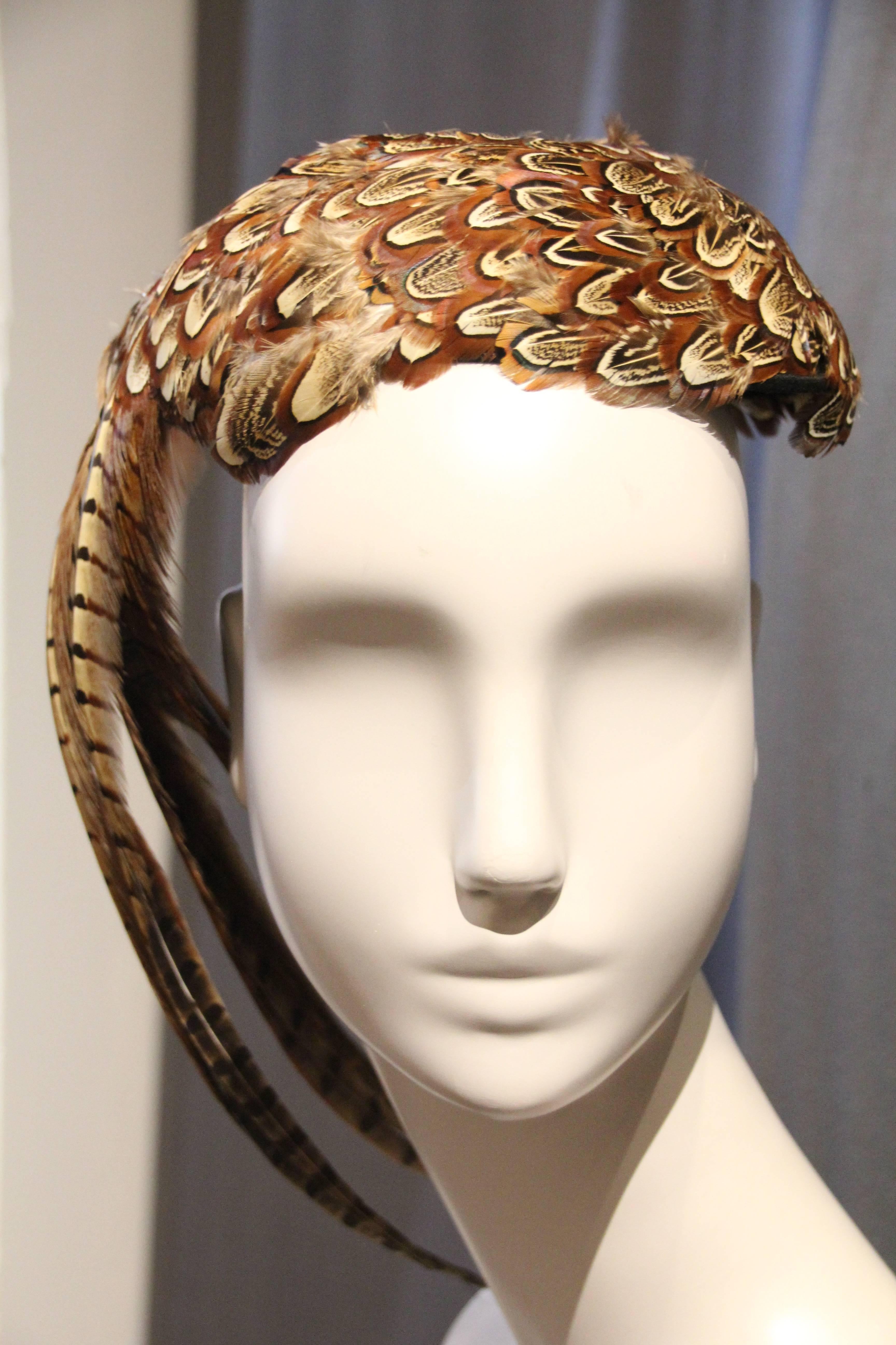 A fabulous 1980s Stuart Jay pheasant feather hat: A small cap style with inside combs for secure comfort, entirely covered with gorgeous pheasant feathers and a full 