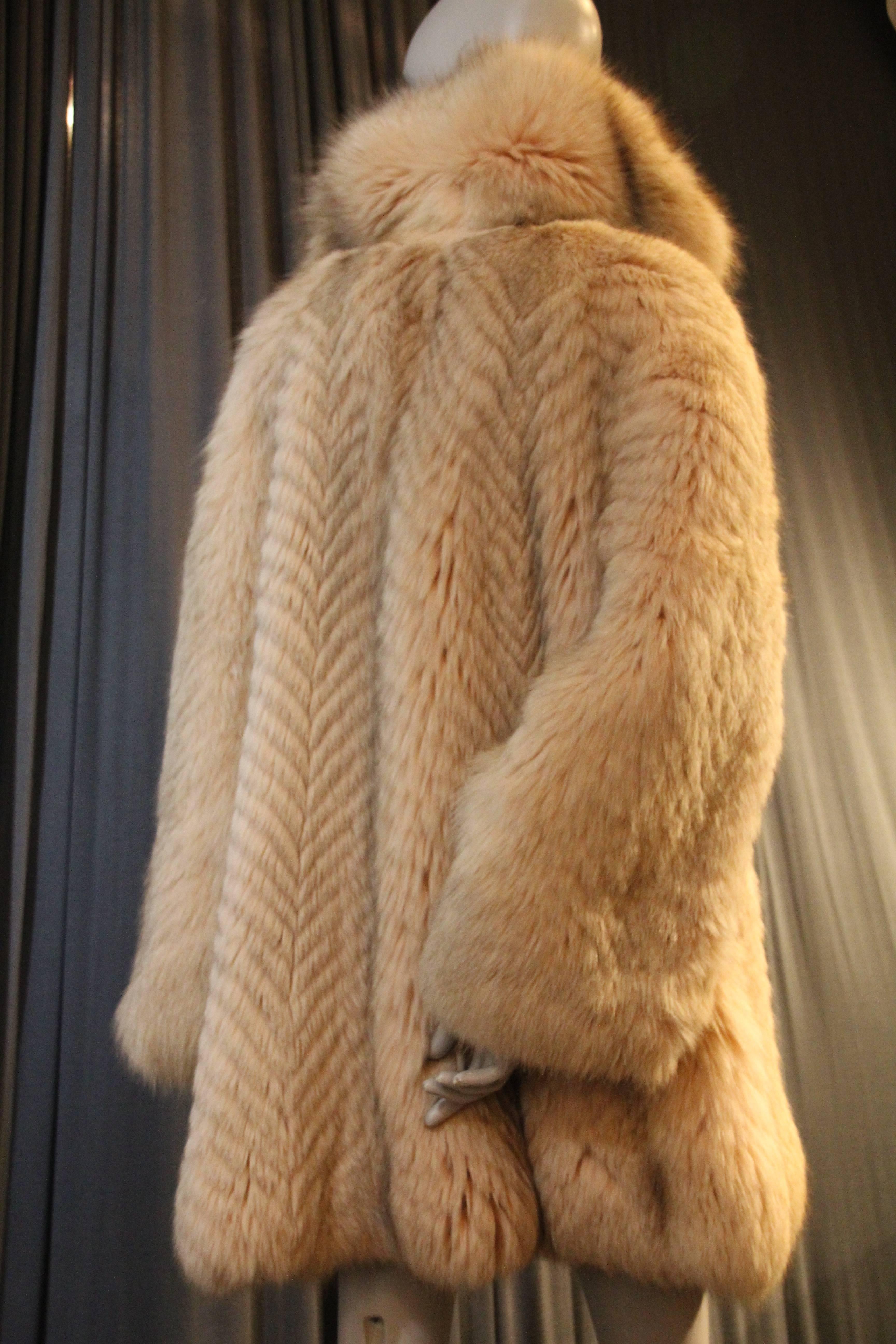 A gorgeous 1980s Fendi fox fur coat:  Swing style with a lush notched collar and front tie. Beige and tan fur cut and sewn in a feathered chevron pattern throughout.  Gorgeous!  