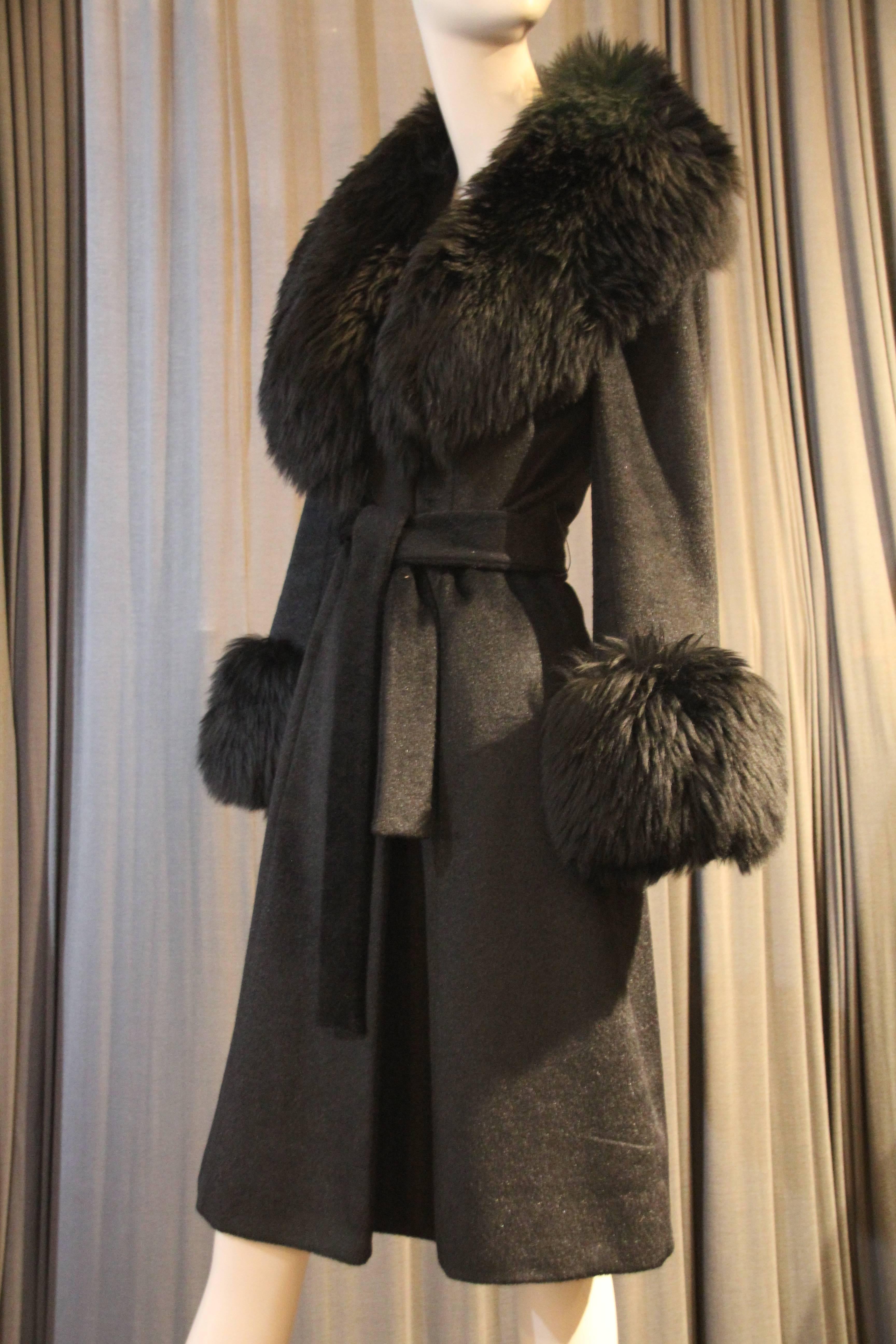 An exquisite 1960s Lilli Ann belted robe-style coat: Blin et Blin french wool outer fabric with a knit wool lining at collar and hems for comfort. An extraordinary plush and extravagant black sheep-skin collar and cuffs give this beauty pizzazz as