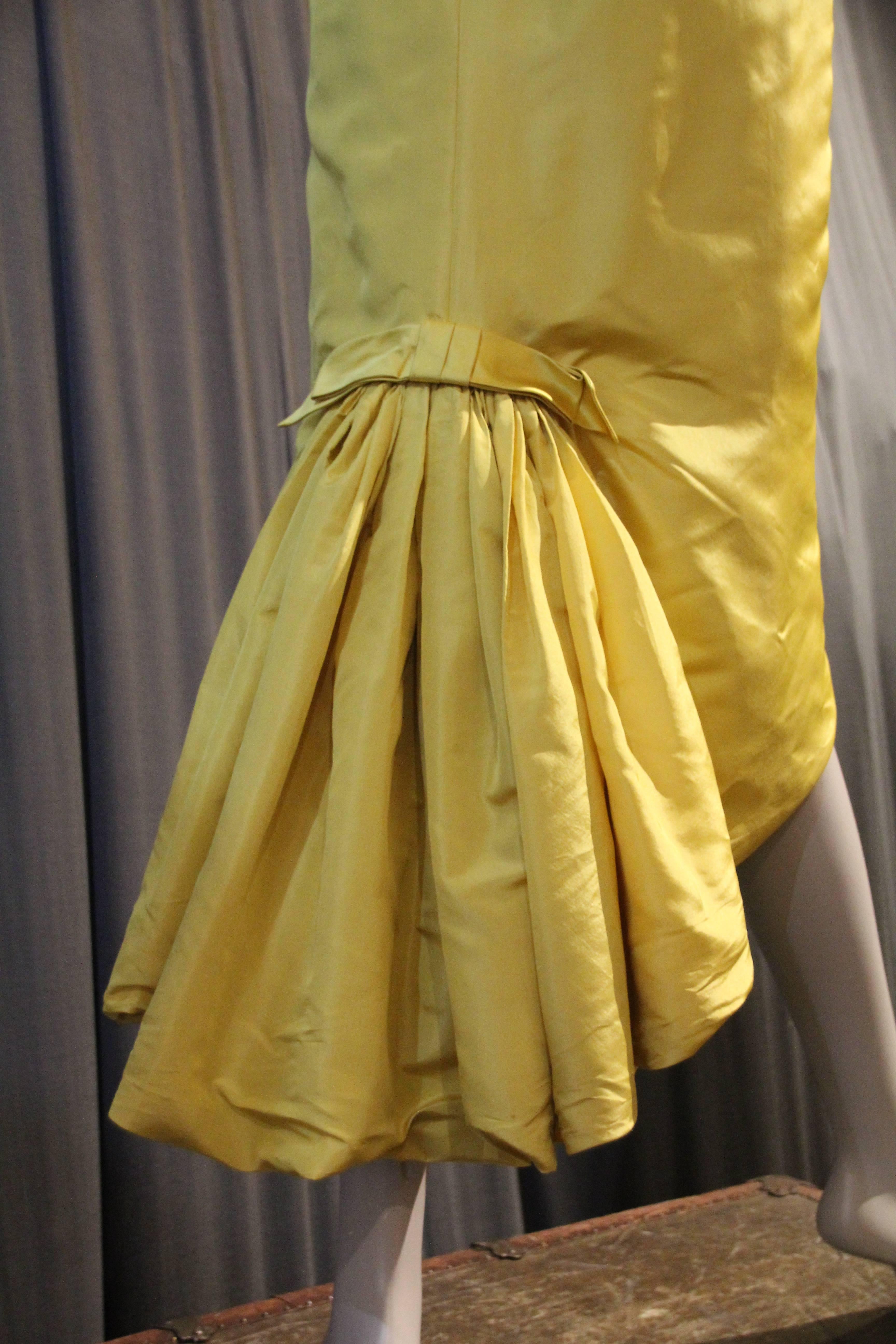 A wonderful late 1950s Philip Hulitar canary yellow silk cocktail dress with a pouf fishtail hem at back.  Satin and matte silk combined in this sophisticated spaghetti strap, form-fitting sheath. front hem is angled up to a point at center. 