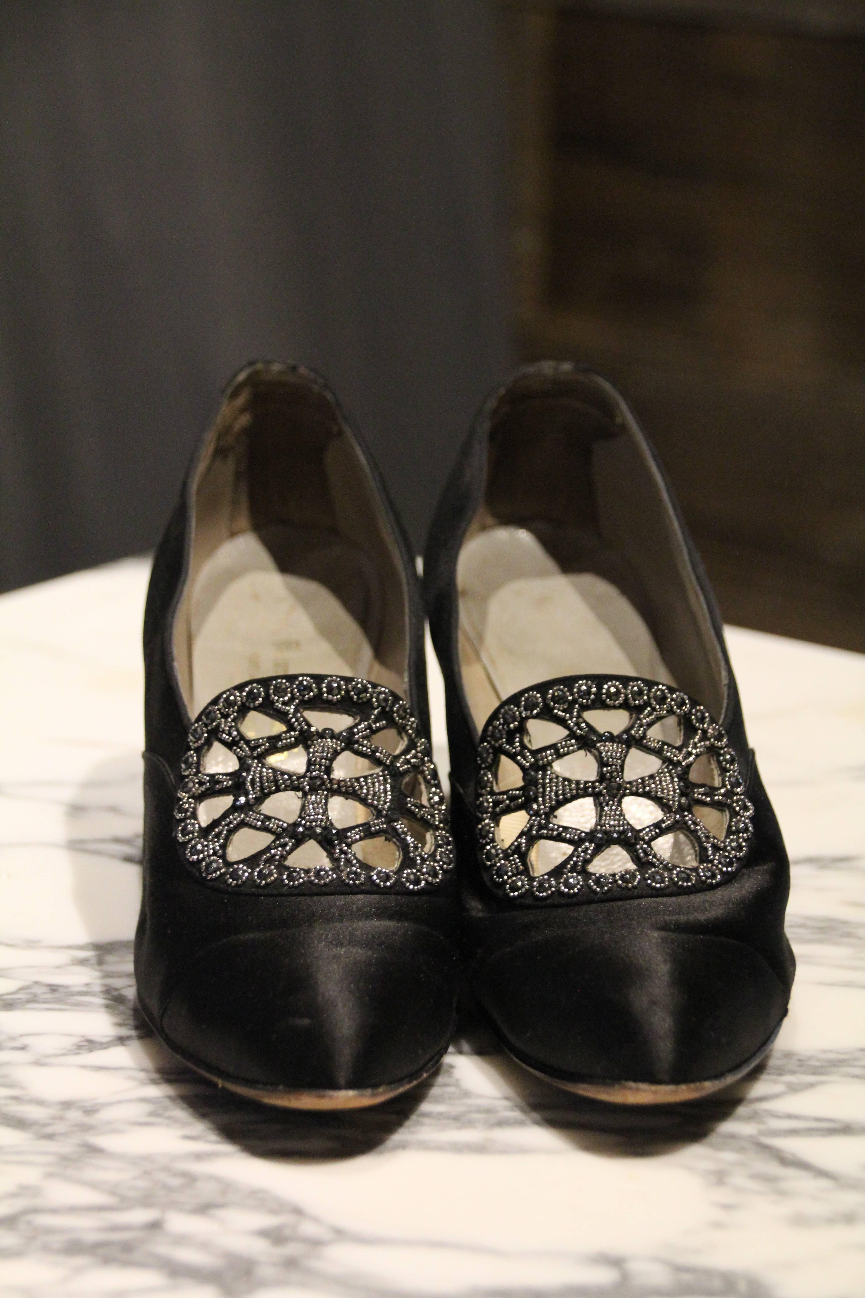 A beautiful Art Deco pair of 1920s Meier and Frank Co. French-made black peau de soie silk pump with a mid-height heel, slightly pointed toe and a beautiful peek-a-boo fan panel at the throat, covered in steel-cut marcasite beads.  Elegant and