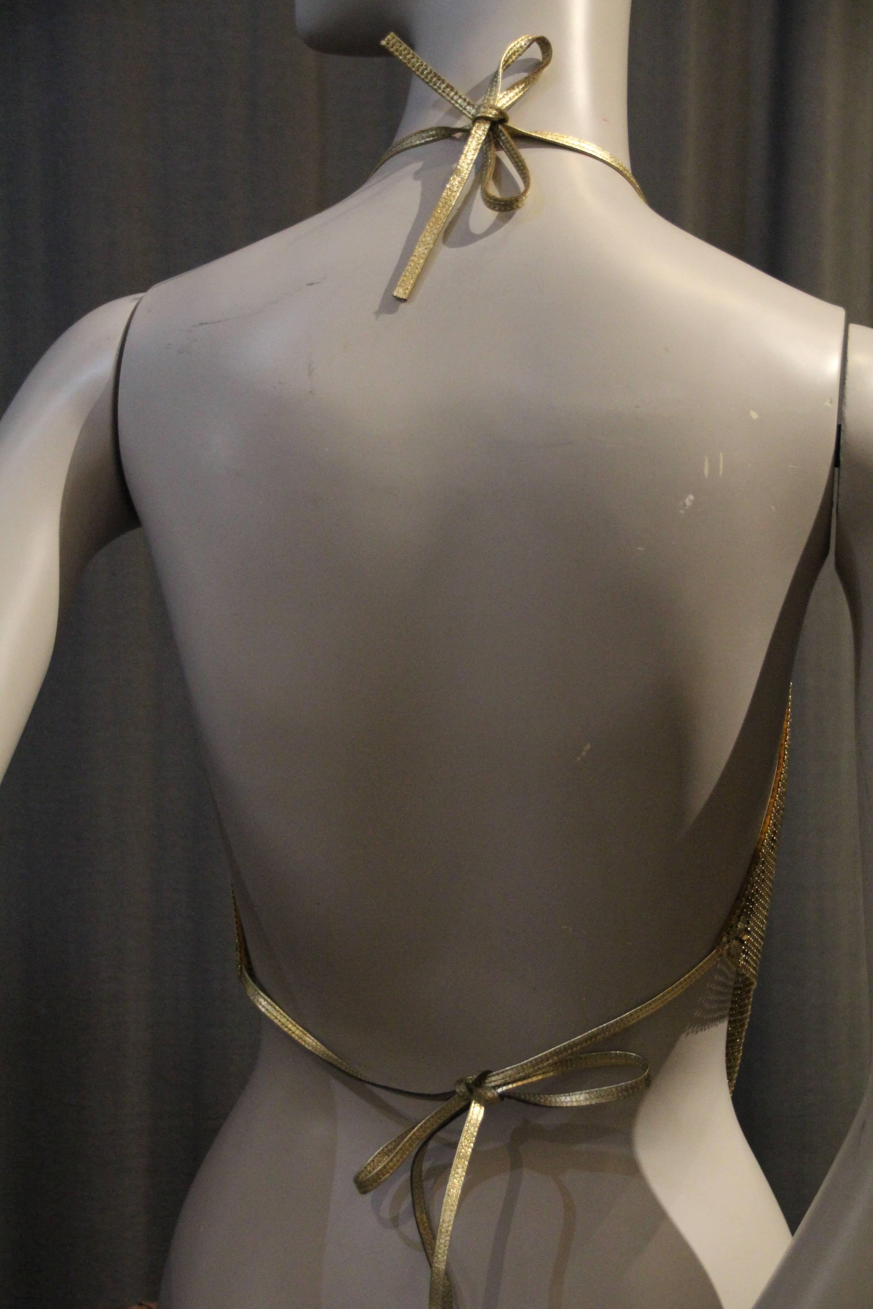 A 1970s Whiting and Davis gold metal mesh bias drape halter top: Seriously sexy and daring molten metal look, with gold metallic leather straps that tie at neckline and at waist!   