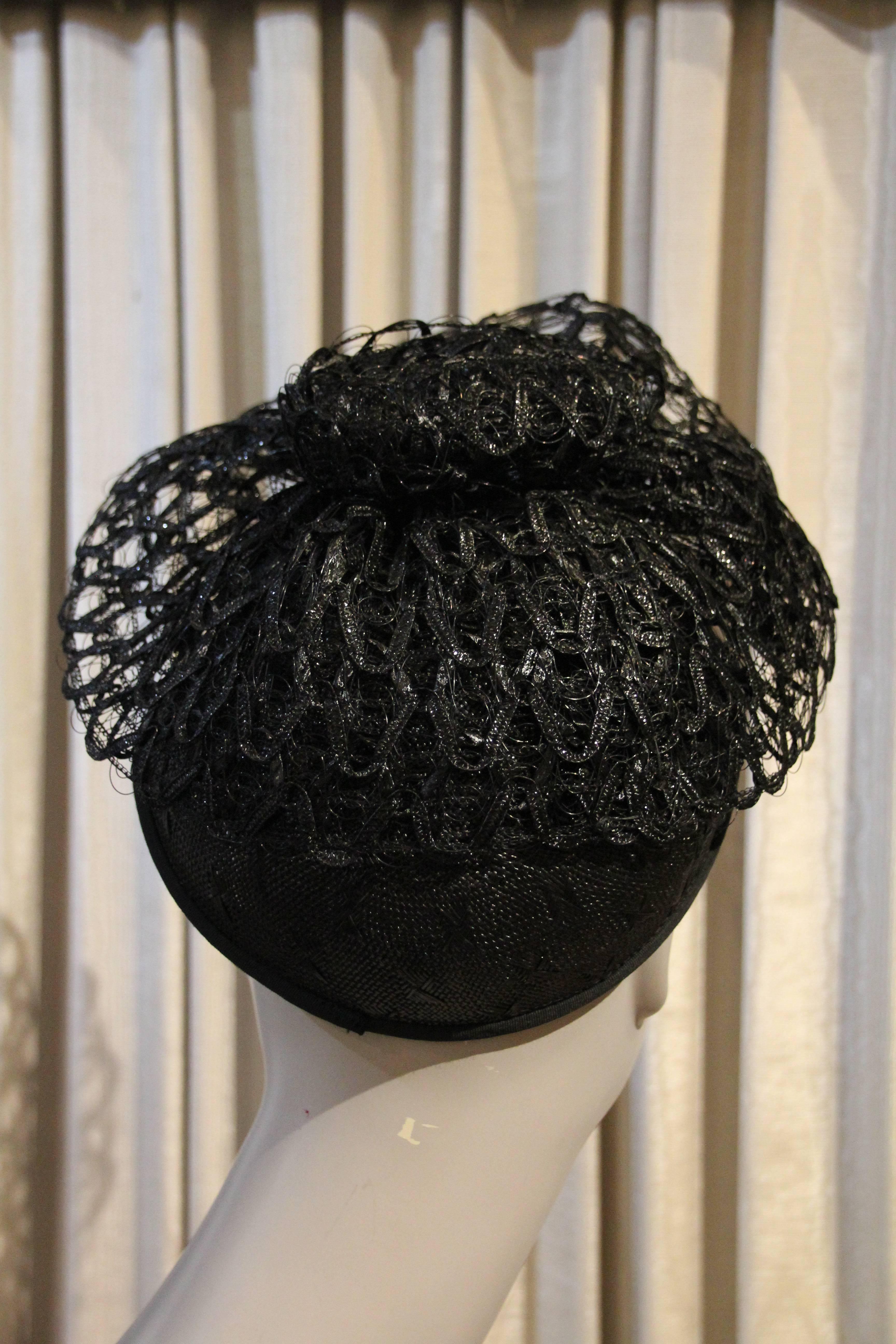 A fabulous 1950s Alex California black straw hat woven in a beautiful pattern (see closeup pic) embellished with a whorl of stiff black horsehair netting for drama!  So chic! 