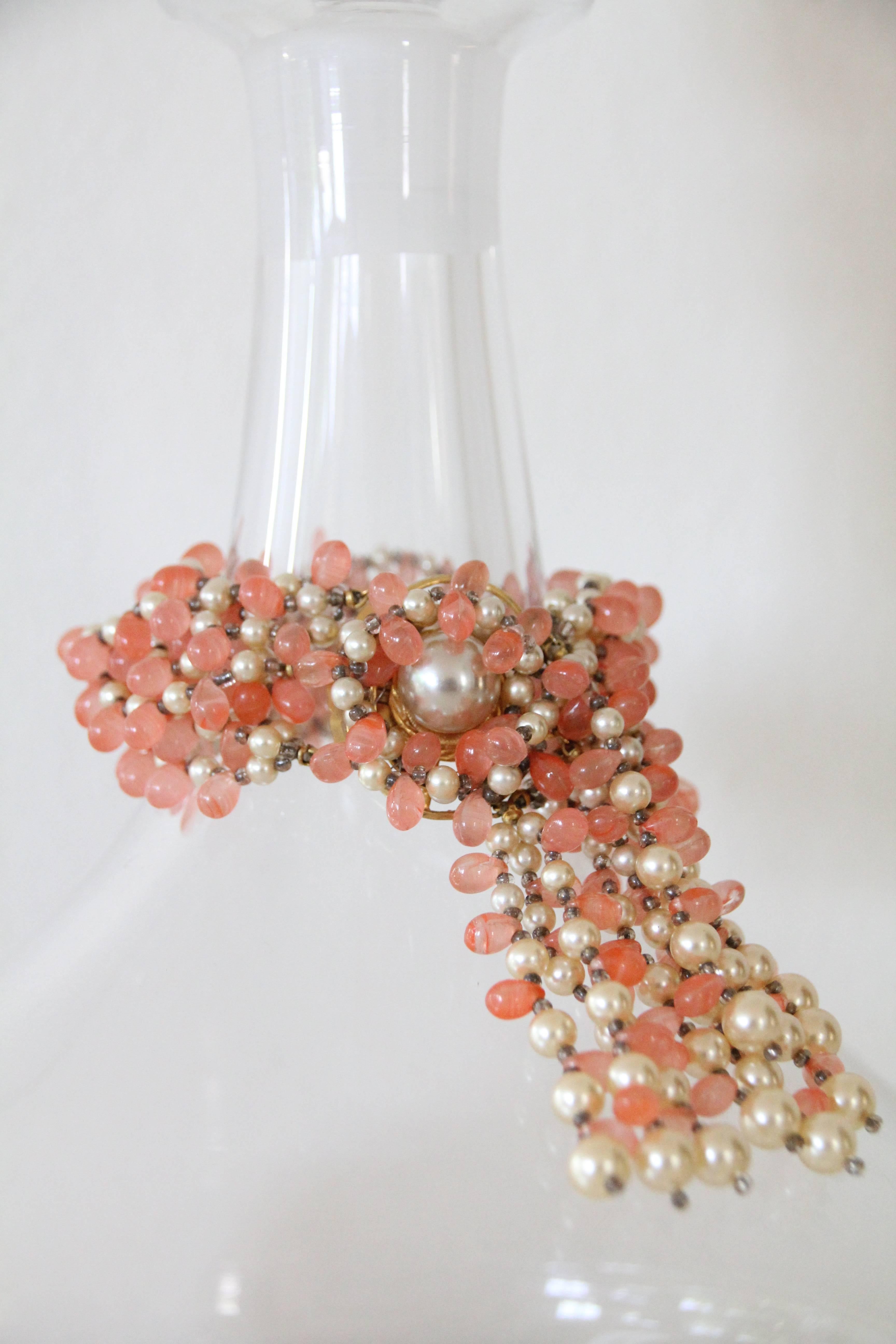 A gorgeous and elegant 1960s Marvella glass salmon roe and faux pearl  beaded multi-strand bracelet with fringe and faux pearl clasp. 