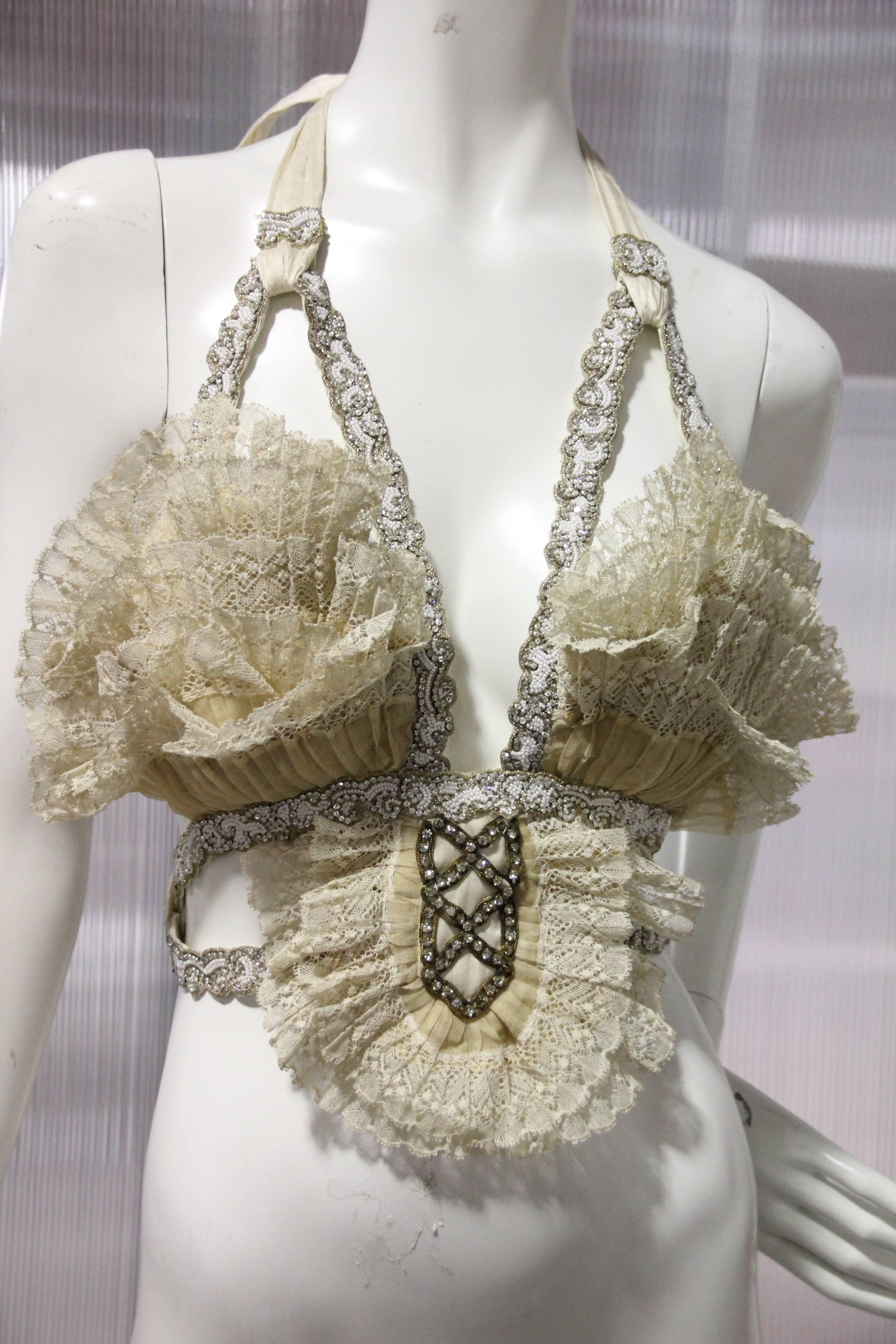 Abbreviated Victorian cream pleated lace bustier with silk ties at back. Silk lined.  Embellished with 1920s rhinestone lattice and modern crystal bead trim, backed with kid leather. 