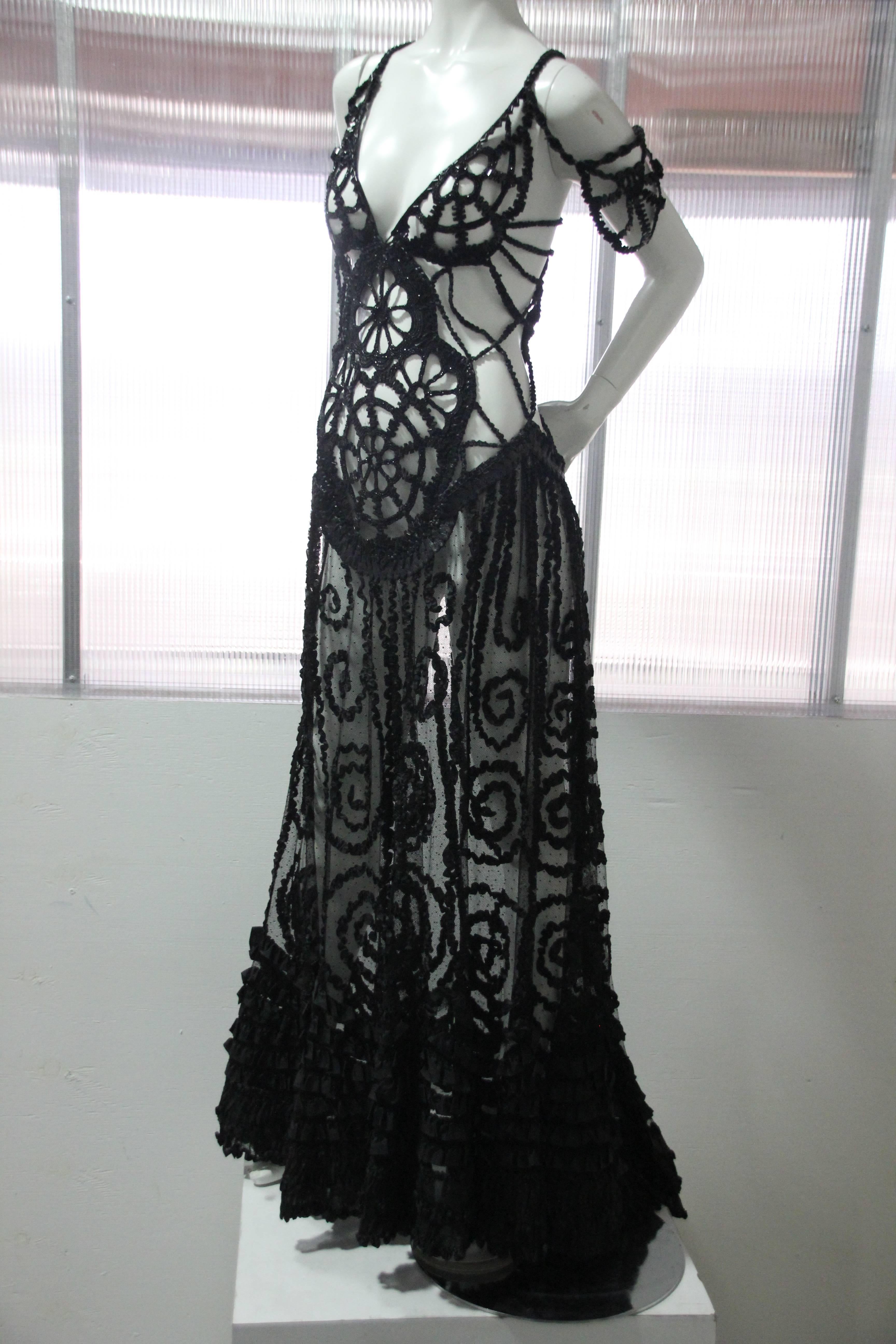 Custom-made black peek-a-boo gown: Flared skirt with train is constructed of pointe d'esprit silk tulle with rows of narrow silk ruffles.  Bodice is constructed of braided and macrame leather and trimmed with Victorian black jet beadwork. Slip-on,