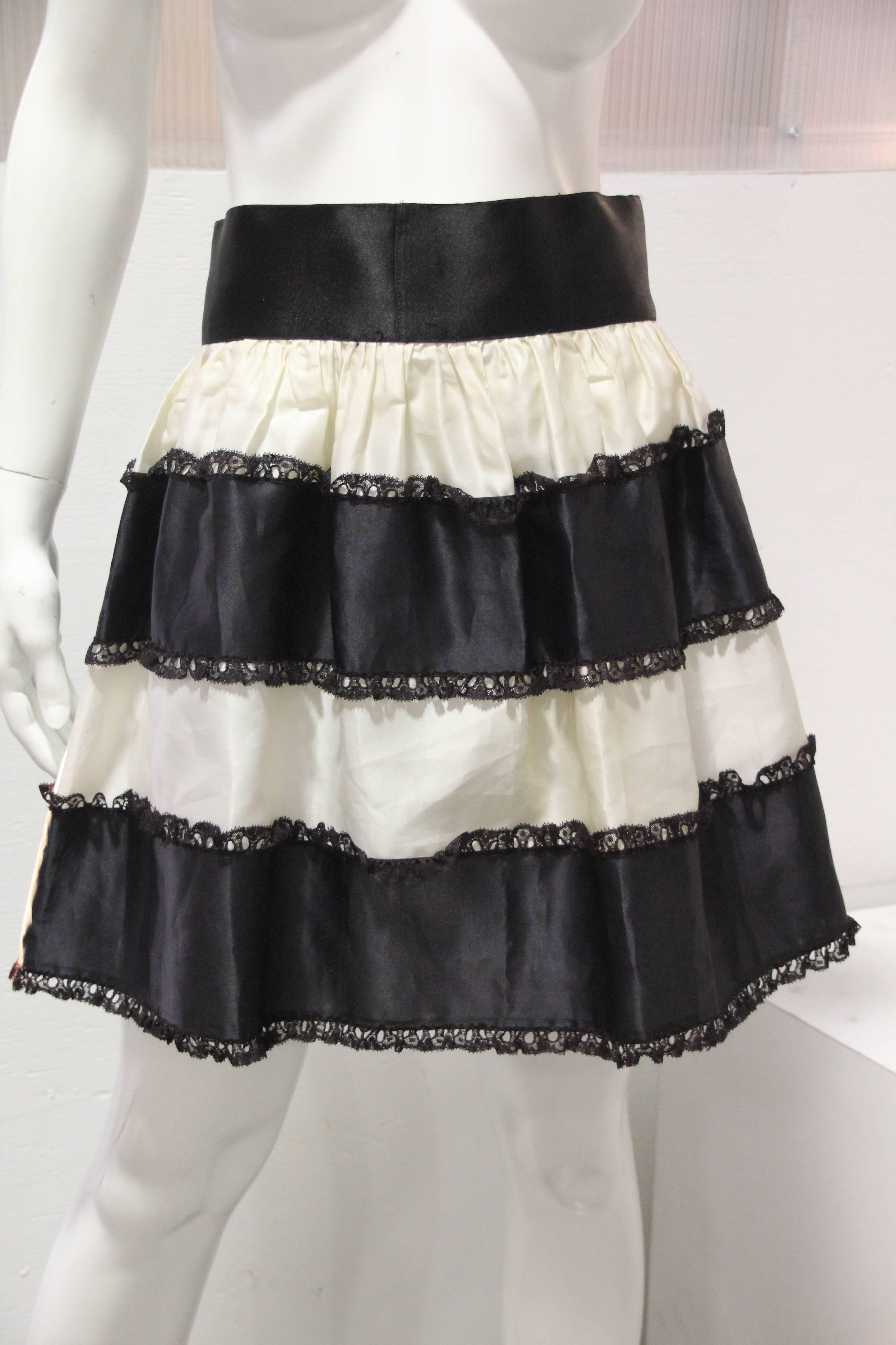1950s French Maid style satin pin-up bra with peek-a-boo sheer panels (size 34B) pair with a tiered organza black and white petticoat. Silk satin waistband to match the bra. 