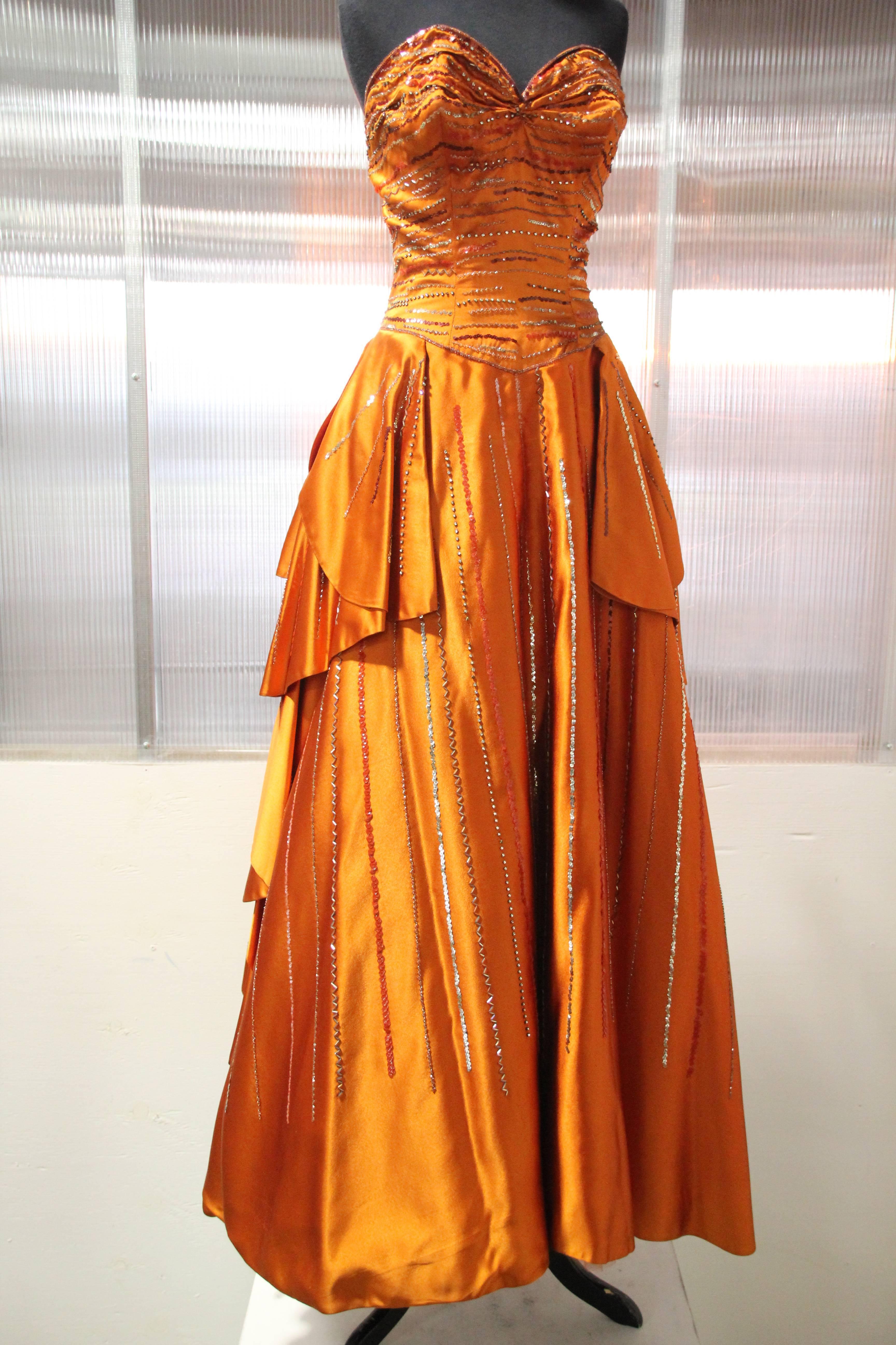 1950s MGM Mme. Etoile by Irene Sharaff couture ball gown in deep persimmon silk satin: Irene Sharaff, 5-time Academy Award Winner for costume design, made this gown for an anonymous MGM star client. This rare and pristine ball gown is constructed in