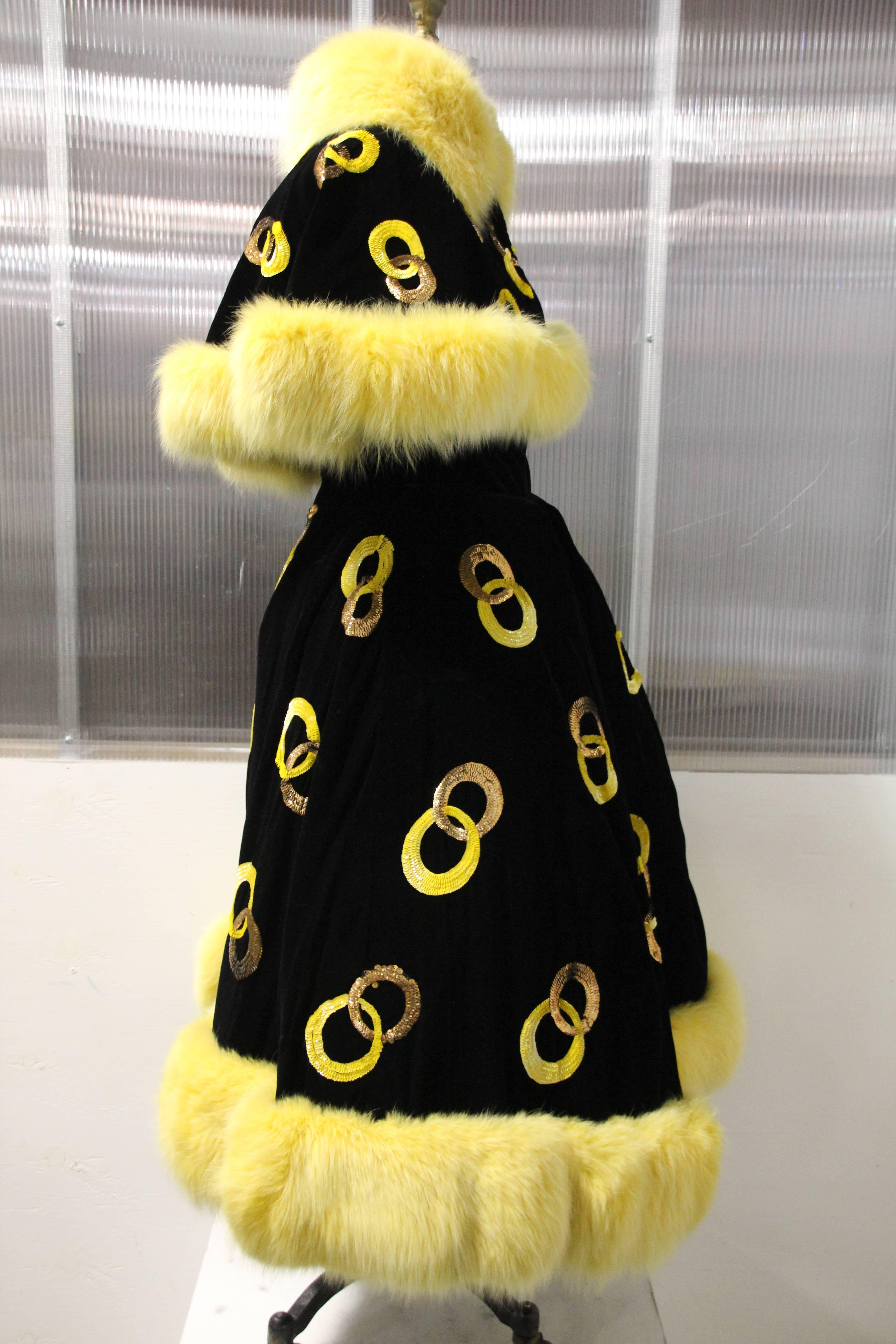 1960s Authentic Ice Follies costume ensemble:  Couture quality, hand made black velvet circle skirt with interlocking sequined circle motifs. Skirt and caplet and collar are hemmed with unusual lemon-hued dyed fox fur.  Extensive underpinnings of