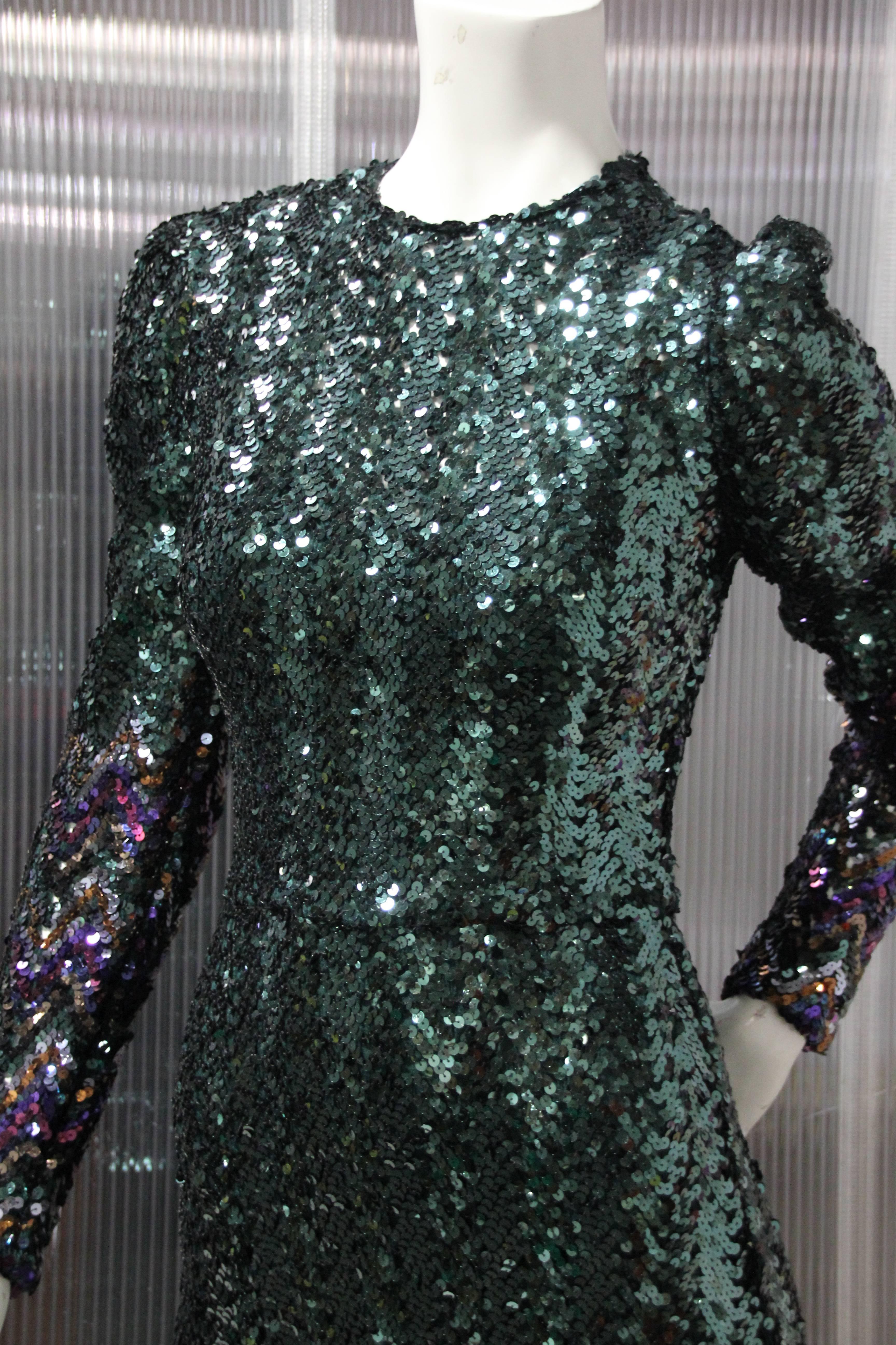 1970's moss green sequin gown is ready to be worn to any social occasion . 
Its long narrow silhouette and back slit makes for a perfect fit.
Fully lined in green acetate and zips up the back for ease. 