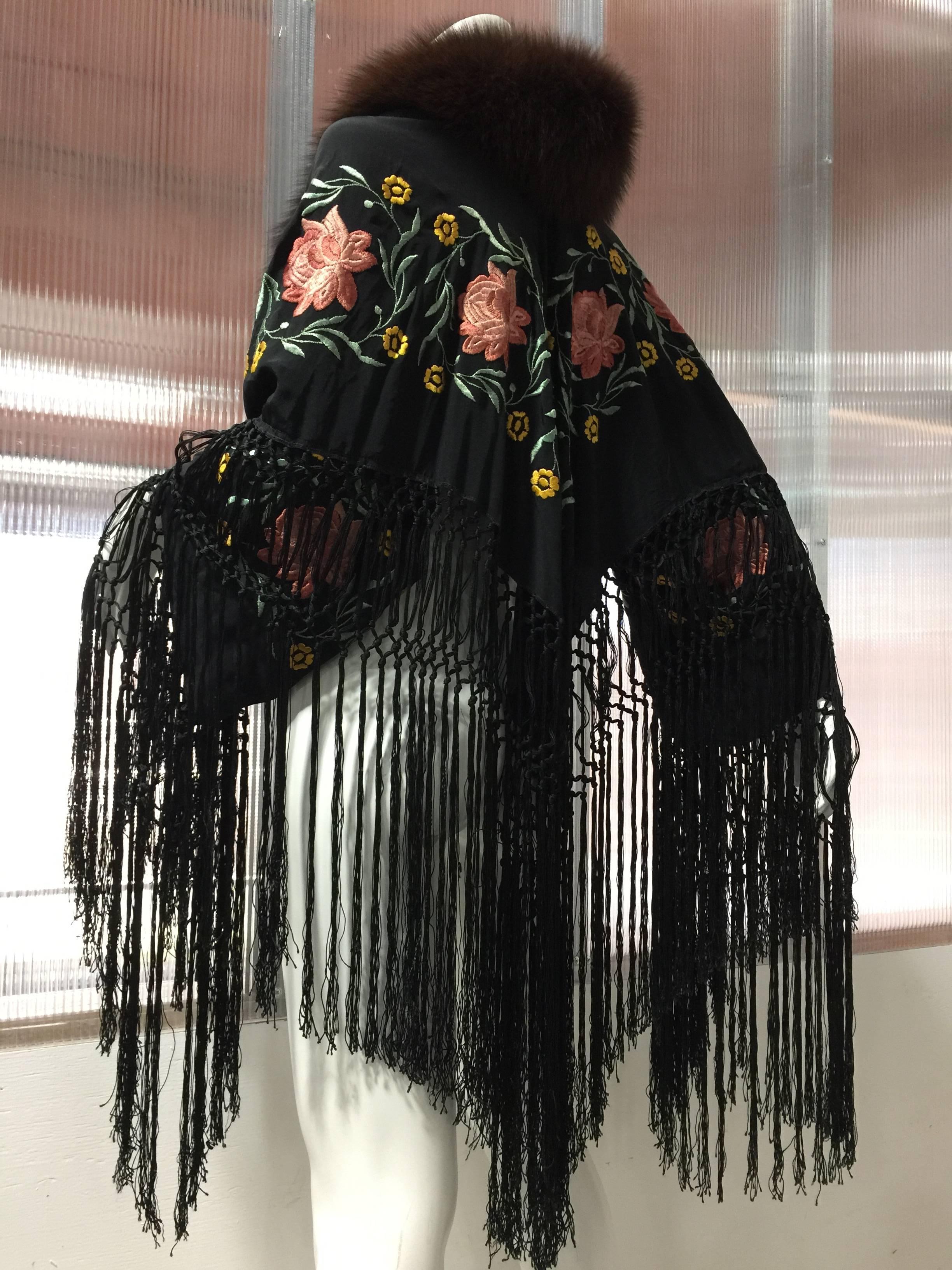 This stunning 1930's Spanish Flamenco silk shawl is cut and designed to fit as if the embroidered shawl was folded in half like the traditional triangular shawls of Spain. This technique was designed to cover the arms and and back while performing .