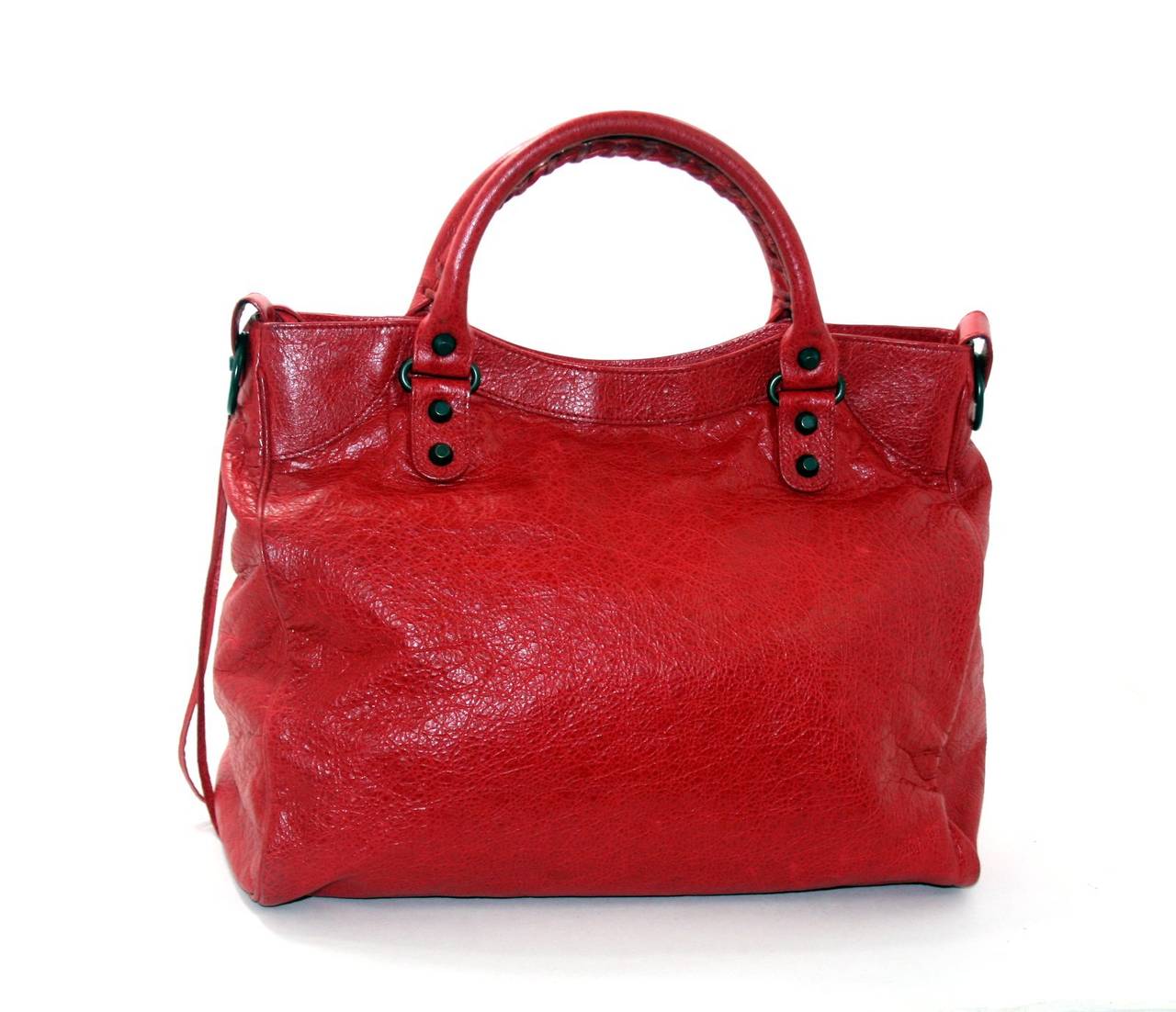 Balenciaga’s Coquelicot Red Arena Classic Velo Bag is a brilliant find in mint condition.  Balenciaga bags are known and loved for their vivid color palettes and moto inspired details.  This eye catching red version is a beautiful addition to any