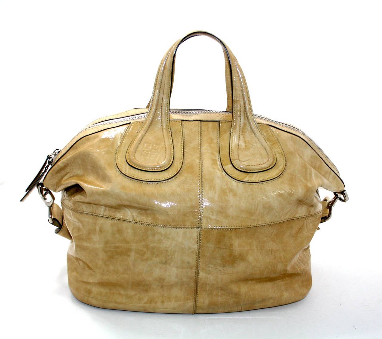 In excellent overall condition, this Givenchy Putty Patent Leather Nightingale is a totally sold out color. There are a few minor markings towards the bottom from normal use, but not very noticeable thanks to the varied coloration.   Extraordinarily