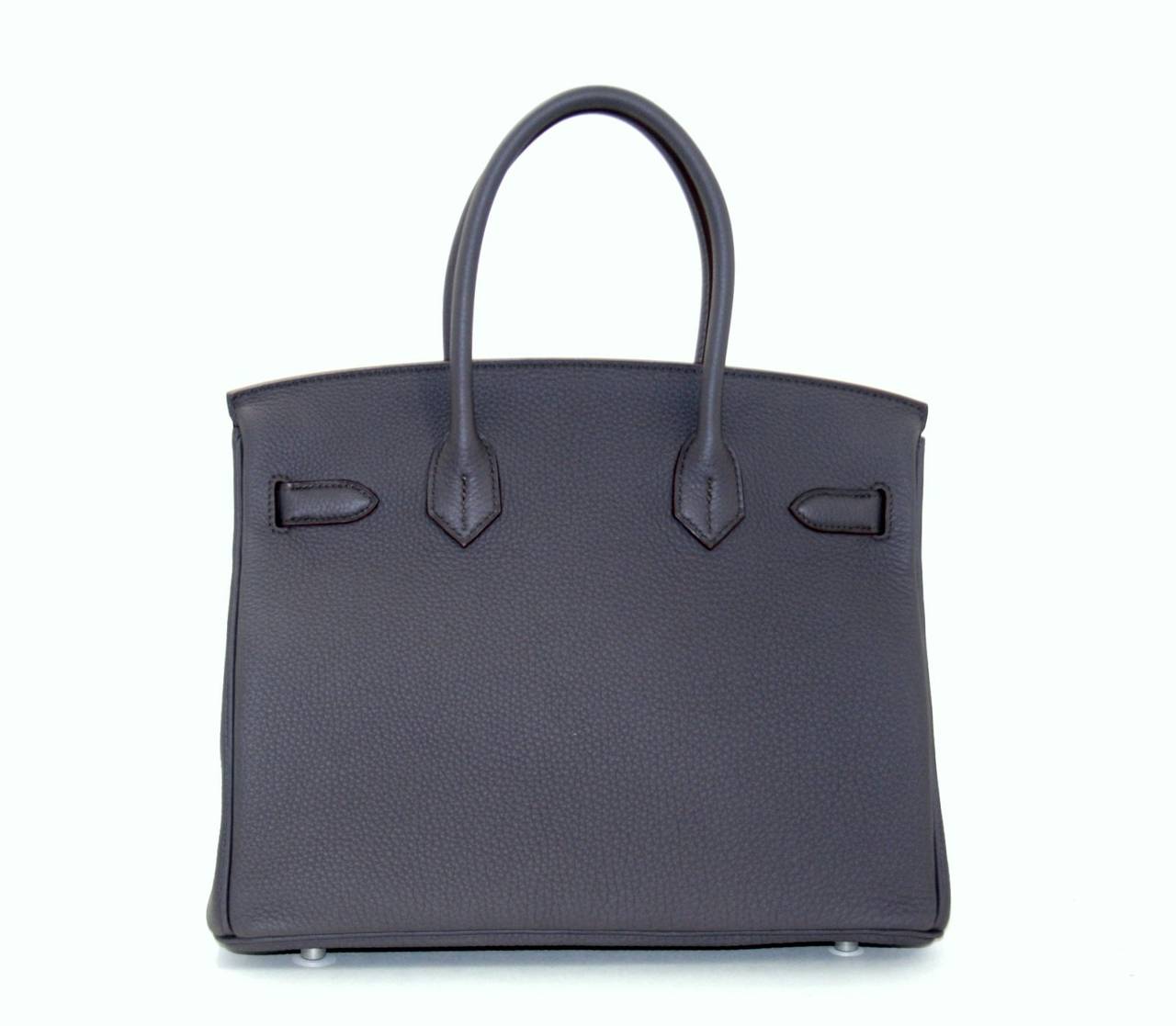 Pristine, store fresh condition (plastic on hardware) Hermès Birkin Bag in Etain Togo, 30 cm size.   Crafted by hand and considered by many as the epitome of luxury items, Birkins are extremely difficult to get. Scratch resistant and richly