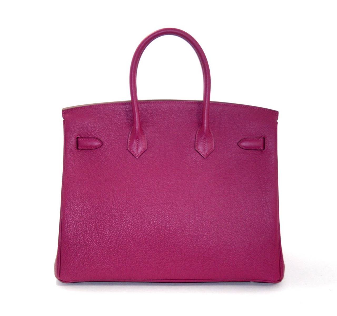 Pristine, store fresh condition (plastic on hardware) Hermès Birkin Bag in Tosca (raspberry pink color) Togo, 35 cm size.   Crafted by hand and considered by many as the epitome of luxury items, Birkins are extremely difficult to get. Scratch