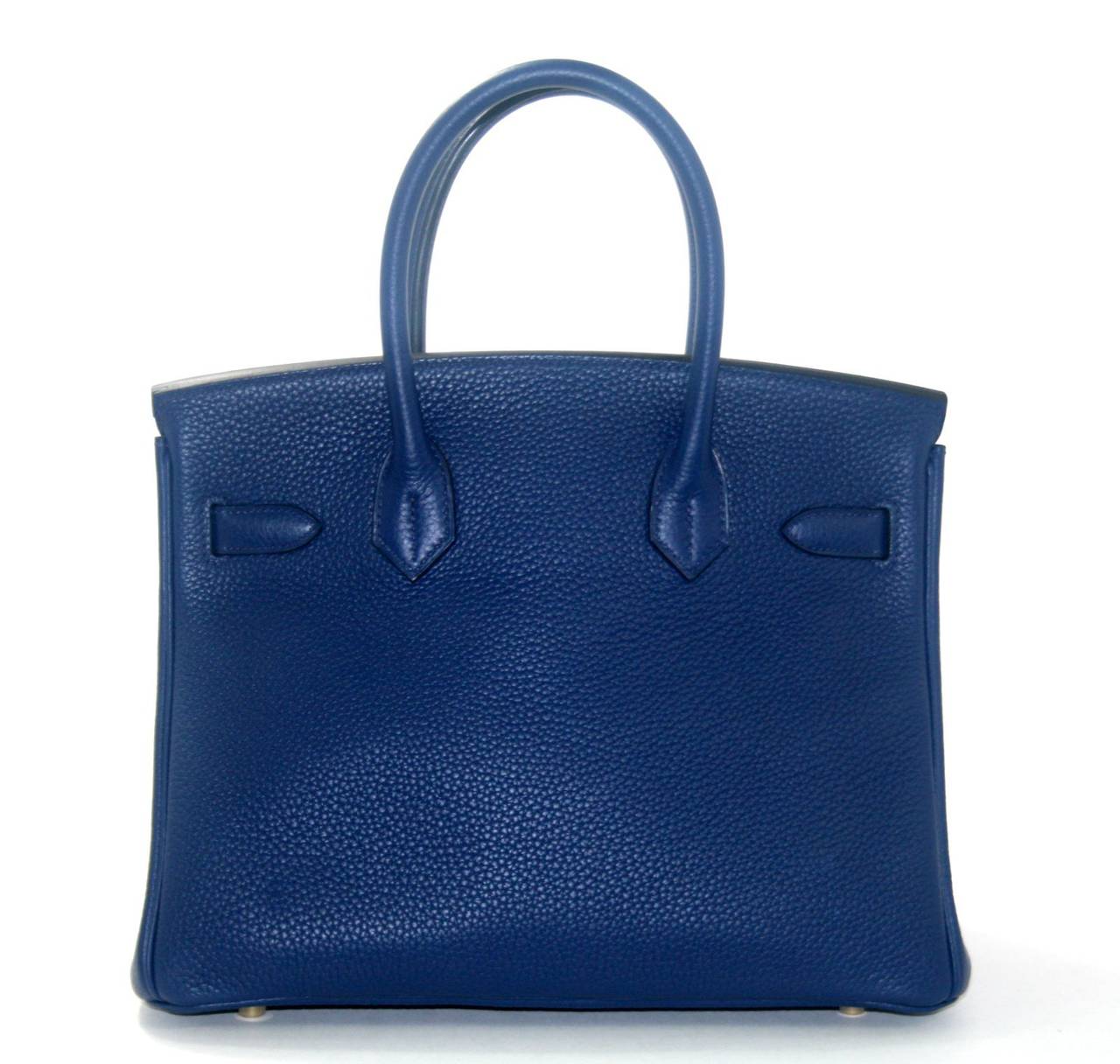 Never before carried, this Hermès Blue Sapphire Clemence 30 cm Birkin is pristine.  The protective plastic remains intact on the hardware and it has been carefully stored.   Considered the ultimate luxury item the world over and hand stitched by