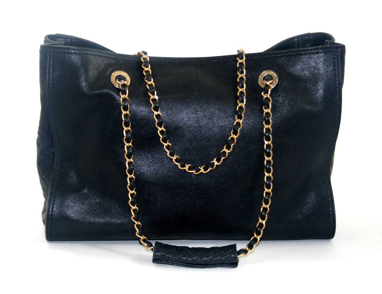 In pristine condition, this Black Calfskin Shopper from Chanel’s spring 2012 collection is a former store display that has never been carried.  The go anywhere piece is beautifully designed with classic Chanel features; it is simply a smart