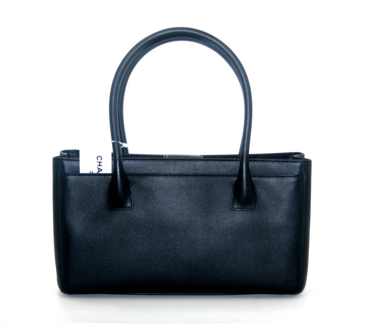In pristine condition, this Black Deerskin Small Cerf Tote from the Chanel Classics Collection is an unworn former store display. The Mini Cerf currently retails for over $3,000.00 with taxes and the price is expected to increase in the near future.