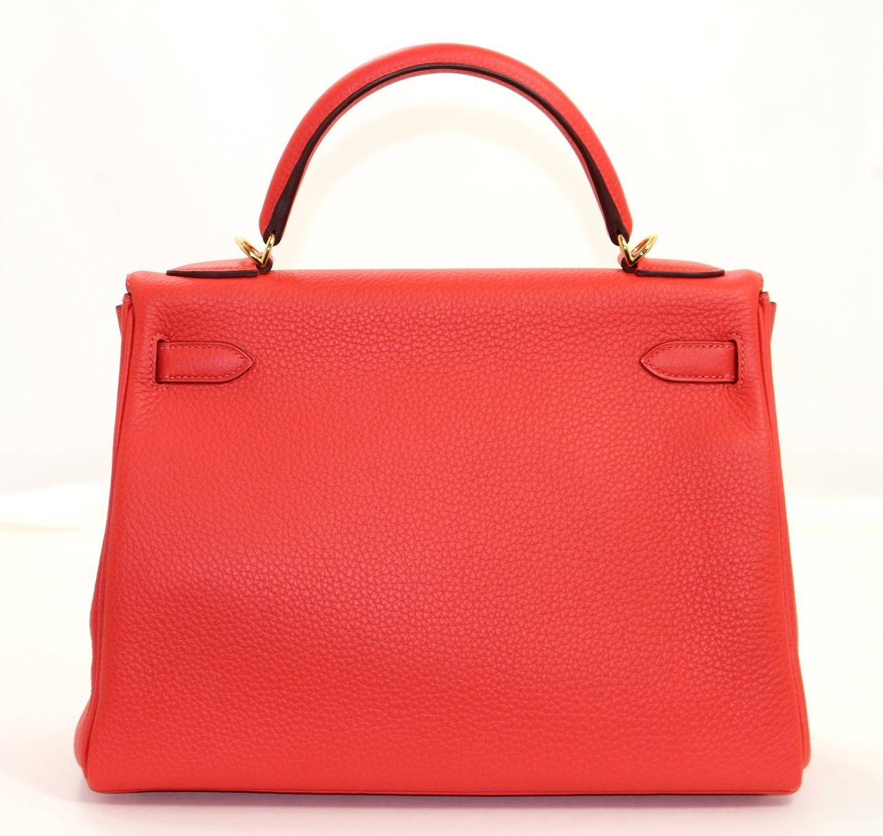 Pristine, store fresh condition (plastic on hardware) Hermès Kelly Bag in Rouge Pivoine Clemence, 32 cm size.   Crafted by hand and considered by many as the epitome of luxury items, Kellys are extremely difficult to get. Scratch resistant and
