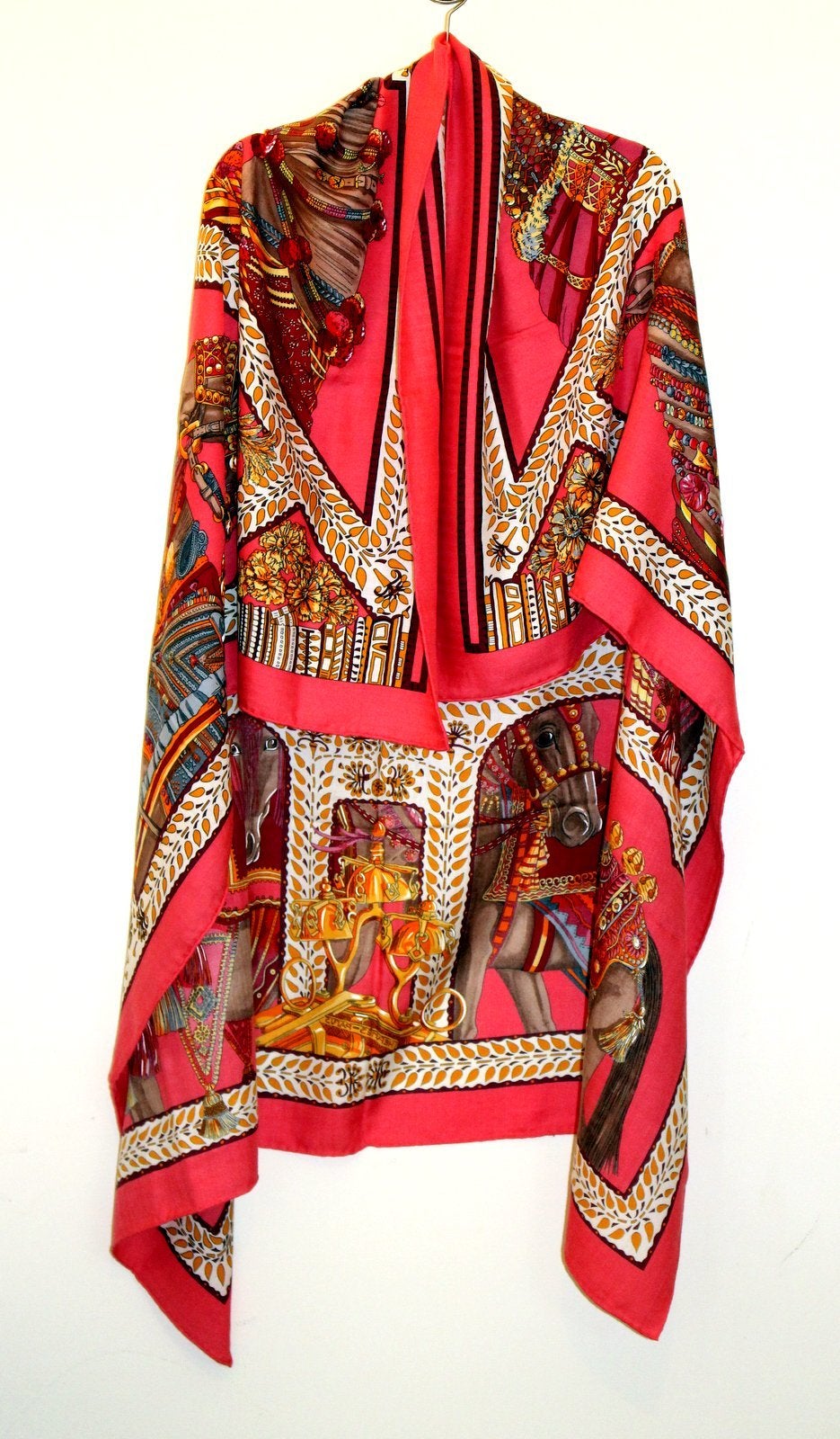 Absolutely pristine, this Hermès La Danse Du Cheval Cashmere and Silk GM Shawl still has the tag attached.   The Annie Faivre design features tassel adorned regal steeds on a fuchsia background with multicolored accents. It may be worn as a shawl or