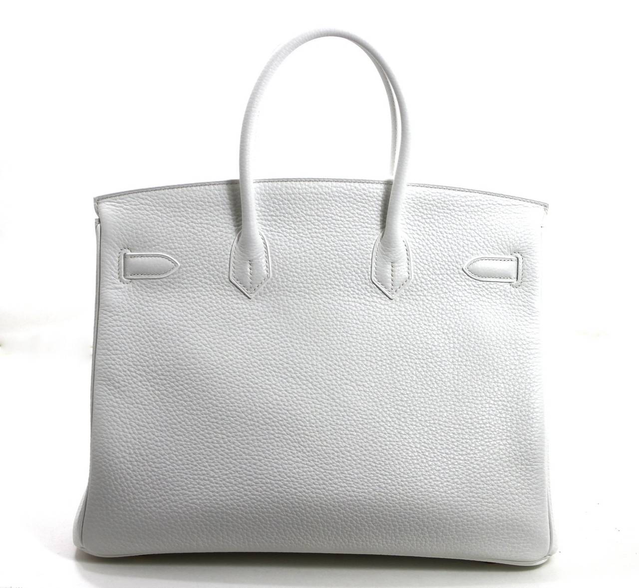 In pristine condition, this Hermès White Clemence Leather 35 cm Birkin has never been carried.  The protective plastic is intact on the gold hardware and the felt has been removed for photography purposes only.     Considered the ultimate luxury