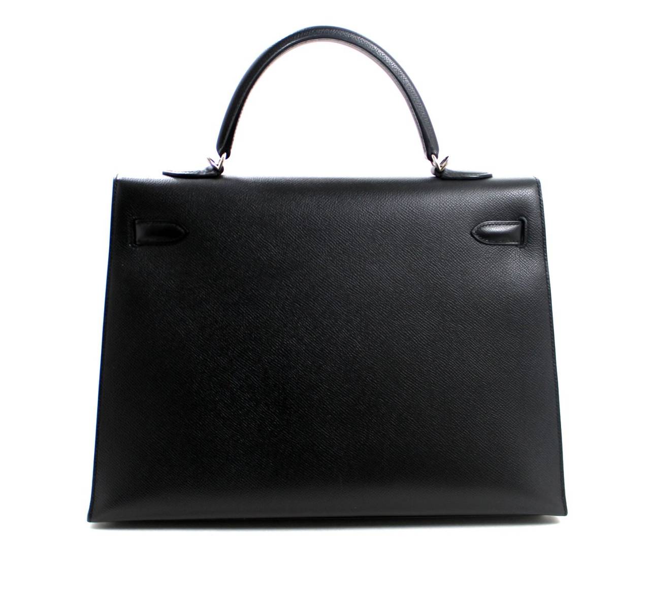 In truly mint condition, this Hermès Black Epsom 35 cm Kelly Sellier has only the most subtle wear that is hardly noticed.   There are several light hardware scratches that we have carefully photographed; this is an expected occurrence with