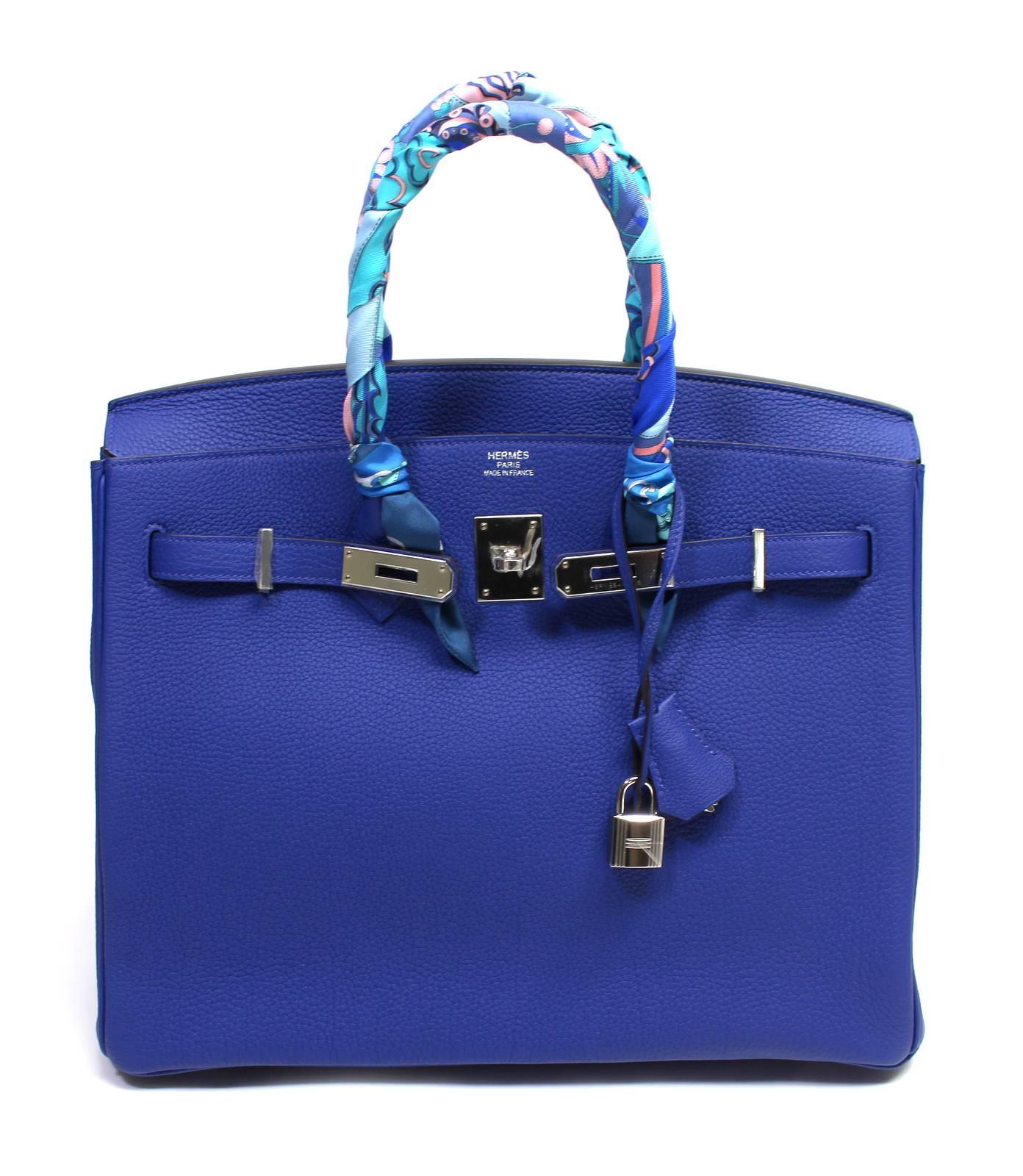 Hermès 35 cm Blue Electrique Togo Birkin is in PRISTINE UNWORN condition.   Protective plastic is intact on the hardware; STORE FRESH.
Considered the ultimate luxury item the world over and hand stitched by skilled craftsmen, wait lists for the