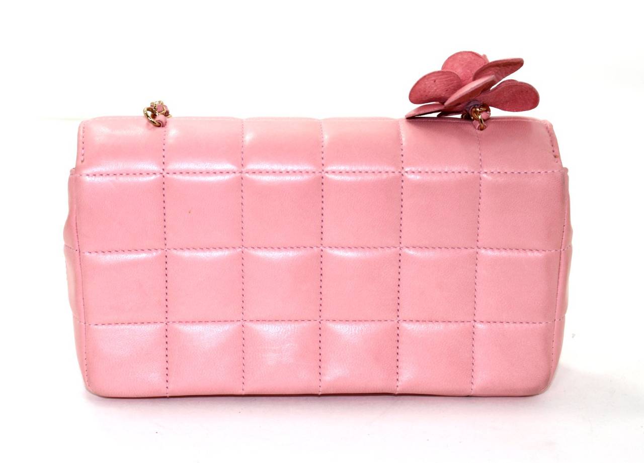 A fantastic find for a smart shopper, this Chanel Pink Lambskin Chocolate Bar Camellia Flap is in excellent condition.  There are a few minor spots towards the bottom and some mild corner darkening from normal wear. Carried on the shoulder or