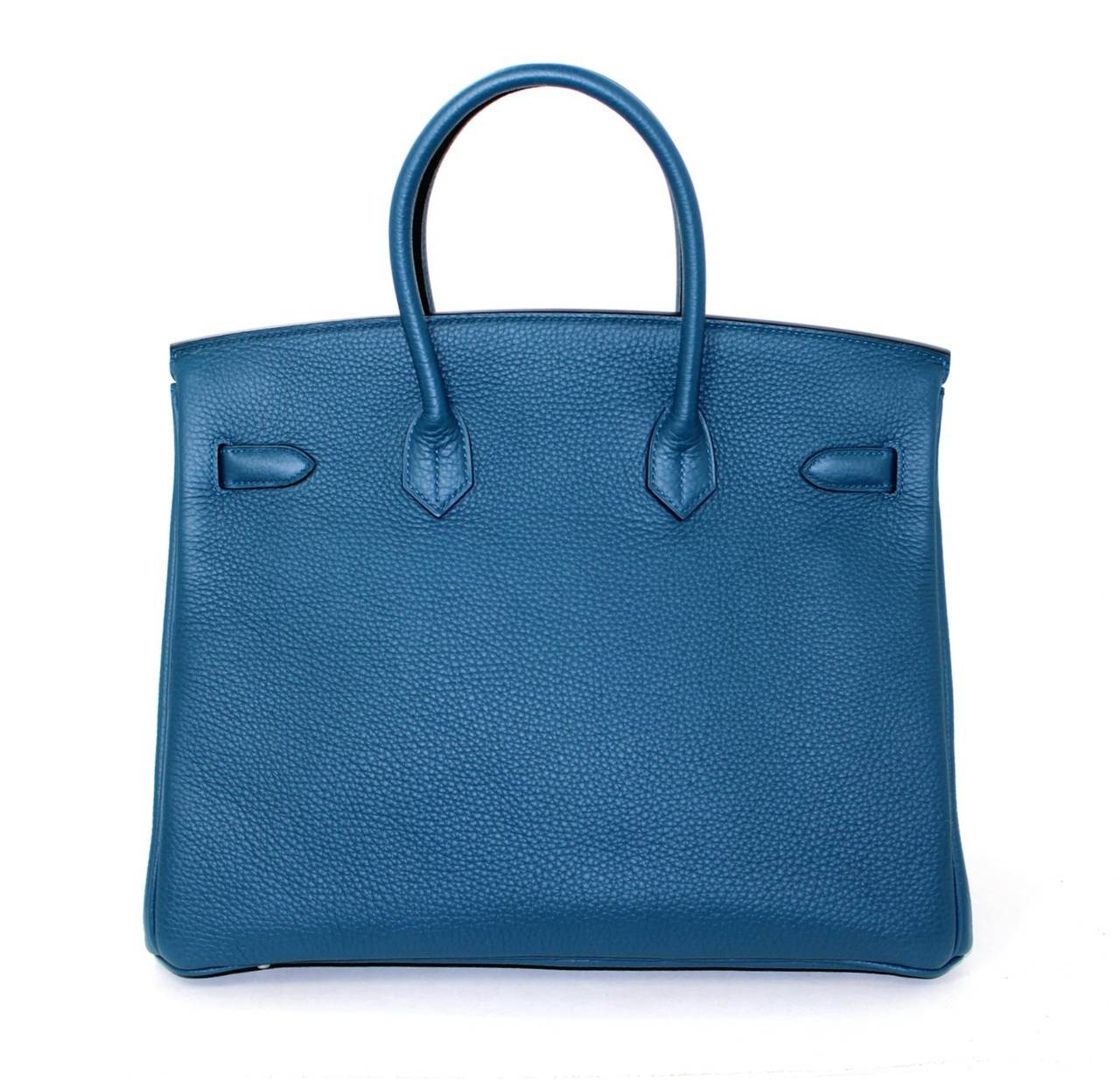 Pristine, new and never carried Hermès Birkin Bag in Blue Colvert Togo Leather, 35 cm size.   Crafted by hand and considered by many as the epitome of luxury items, Birkins are extremely difficult to get. Scratch resistant and richly textured, Blue