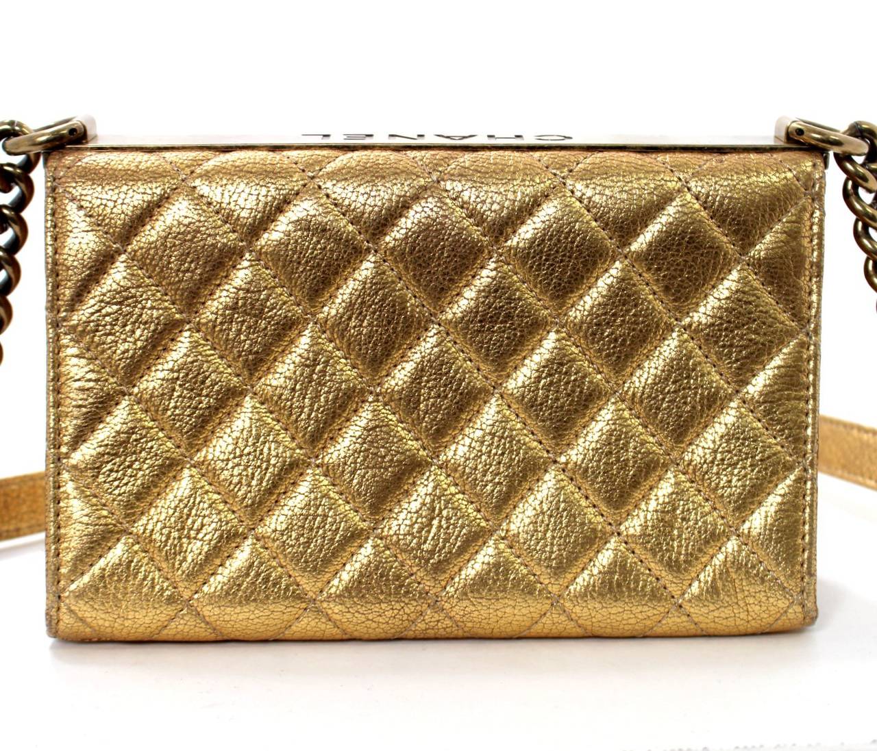 Chanel Rita Small Flap Bag in Metallic Gold Leather, MINT condition.    From the 2013 Cruise Collection, original retail was over $2,700.00 with taxes.  
Crackled metallic gold leather is quilted in signature Chanel diamond stitched pattern.
