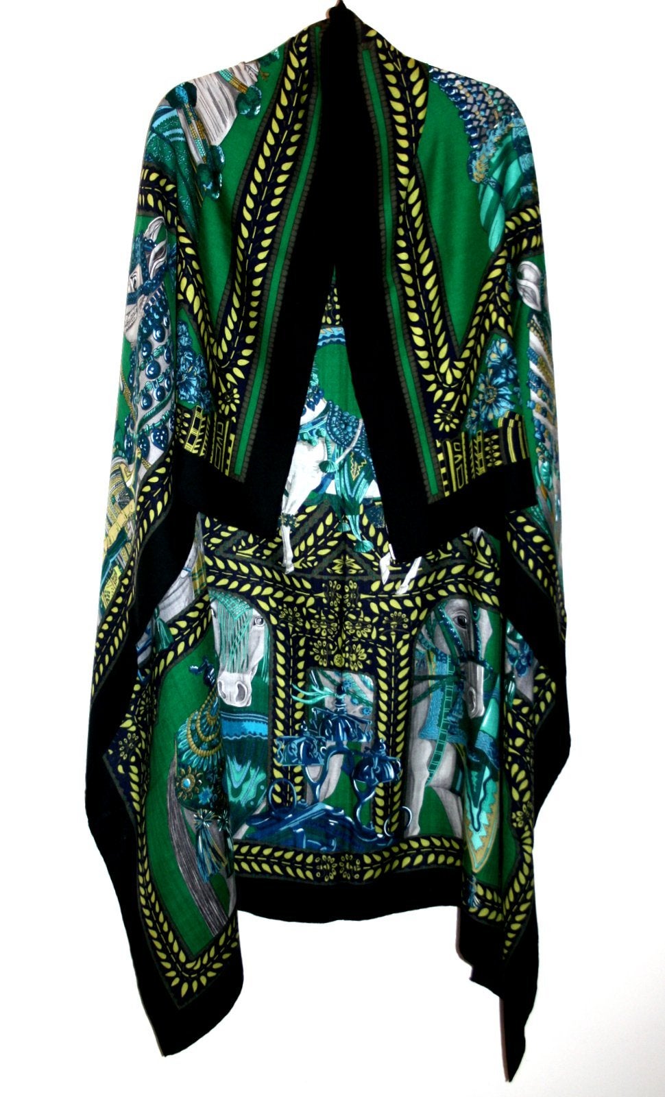 Never worn, pristine with tag attached.  Hermès La Danse du Cheval Cashmere and Silk GM Scarf 140.  Vert, Noir and Turquoise.  Designed by artist Annie Faivre.
  
Bejeweled and tasseled white steeds, known as the Marwari, cover the landscape of