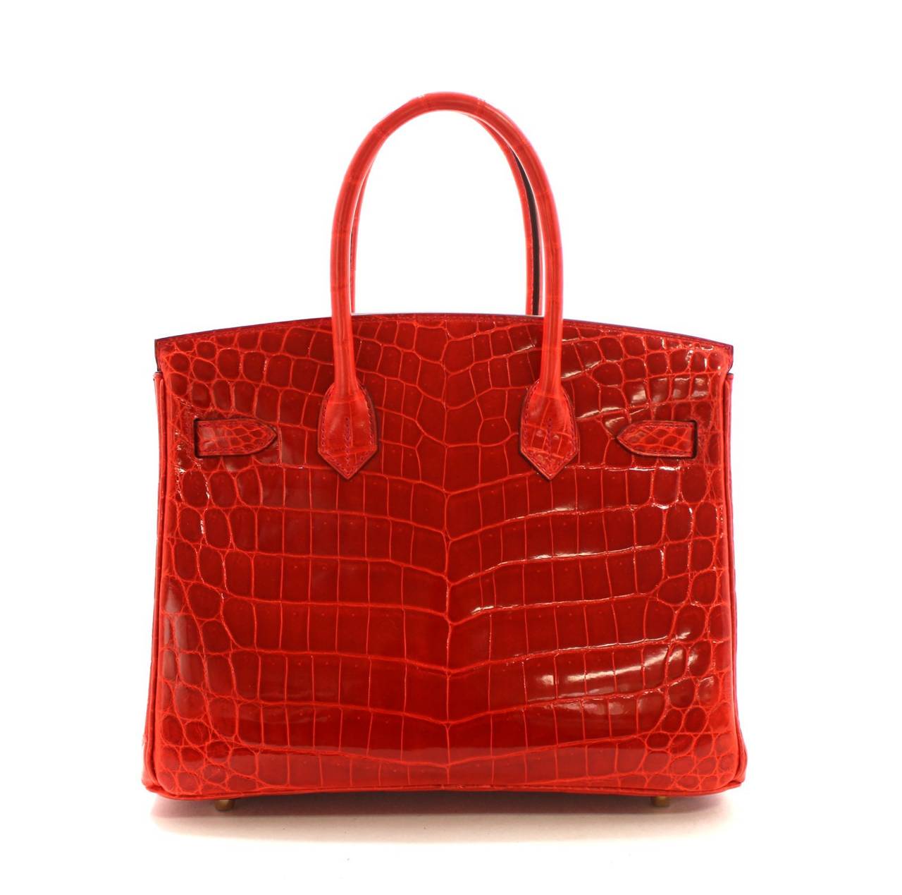 Pristine, store fresh condition (plastic on hardware) Hermès Birkin Bag in Geranium Nilo Crocodile with gold, 30 cm size.  
 Crafted by hand and considered by many as the epitome of luxury items, Birkins are extremely difficult to get. Exotic