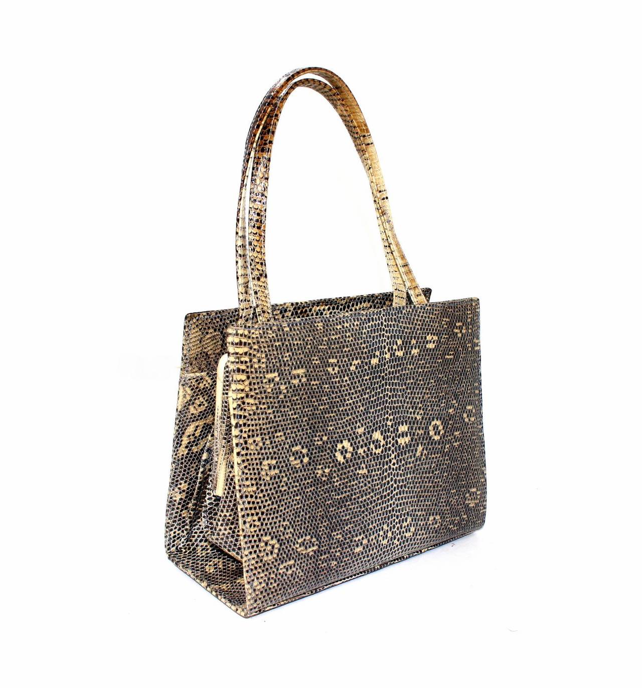 Lambertson Truex Grey and Beige Lizard Handbag-  MINT Original retail $500.00.
Grey and beige lizard skin small bag has silver tone LT hardware accents.  Framed central compartment accesses the light blue leather interior.  Double handles are