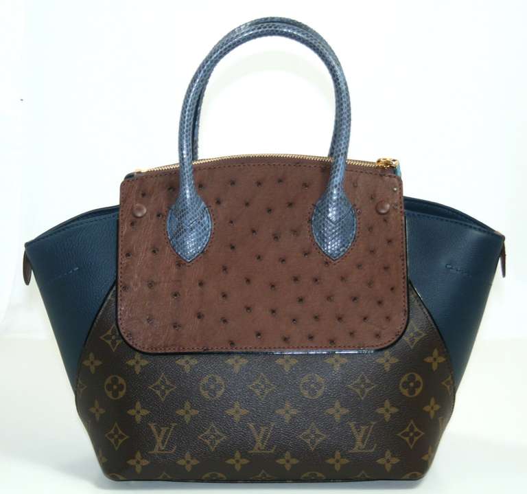 Pristine and never carried, this Louis Vuitton Blue Majestueux PM Tote has the plastic intact on the hardware.  The rare limited edition style combines exotic skins with signature LV monogram canvas to create the ultimate piece for any collection. 