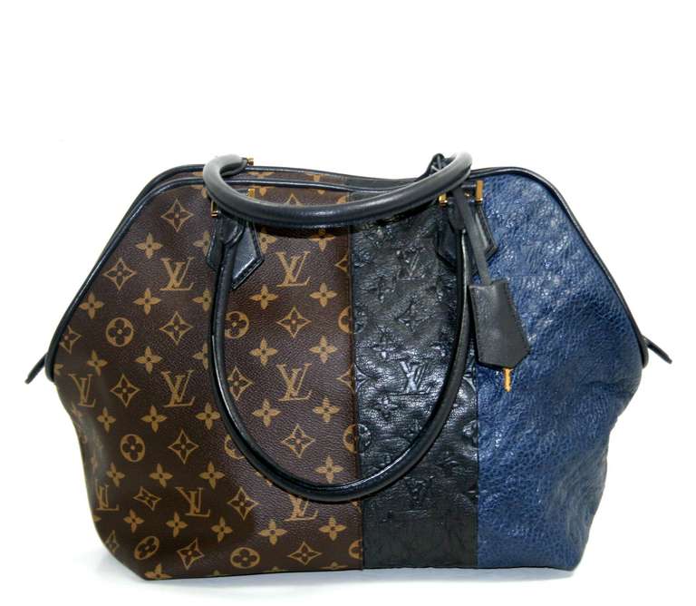 This authentic Louis Vuitton Marine Monogram Blocks Zipped Tote is a former store display in nearly pristine condition.  The limited edition style is a Marc Jacobs design from the pre-fall 2011 collection.  Quite rare, this unique piece is a must