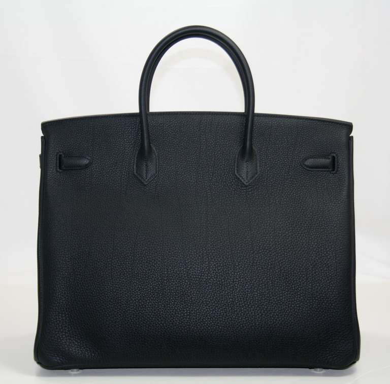 Hermès Black Togo Birkin Bag, 40 cm, in pristine condition; store fresh with plastic on hardware.  Crafted by hand and considered by many as the epitome of luxury items, Birkins are extremely difficult to get. Scratch resistant and richly textured,