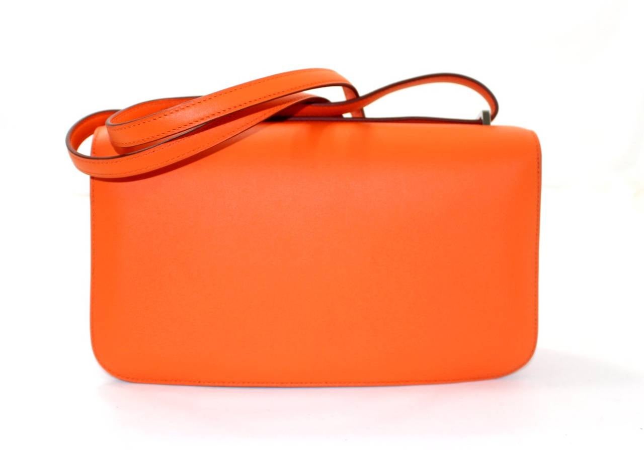 Hermès Orange Swift Constance Elan- PRISTINE unworn condition. The Constance is extremely coveted and a favorite among celebrities.  
 The Constance has simple clean lines and brings to mind an equestrian saddle bag. Worn over the shoulder or