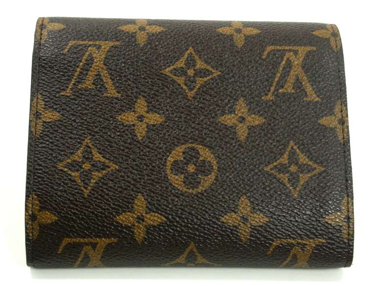 Louis Vuitton’s Monogram Joey Wallet is a current style in new condition with the original box.  The highly functional yet chic wallet is sold out online and retails for over $835.00 with taxes.
Signature Louis Vuitton brown and tan monogram canvas